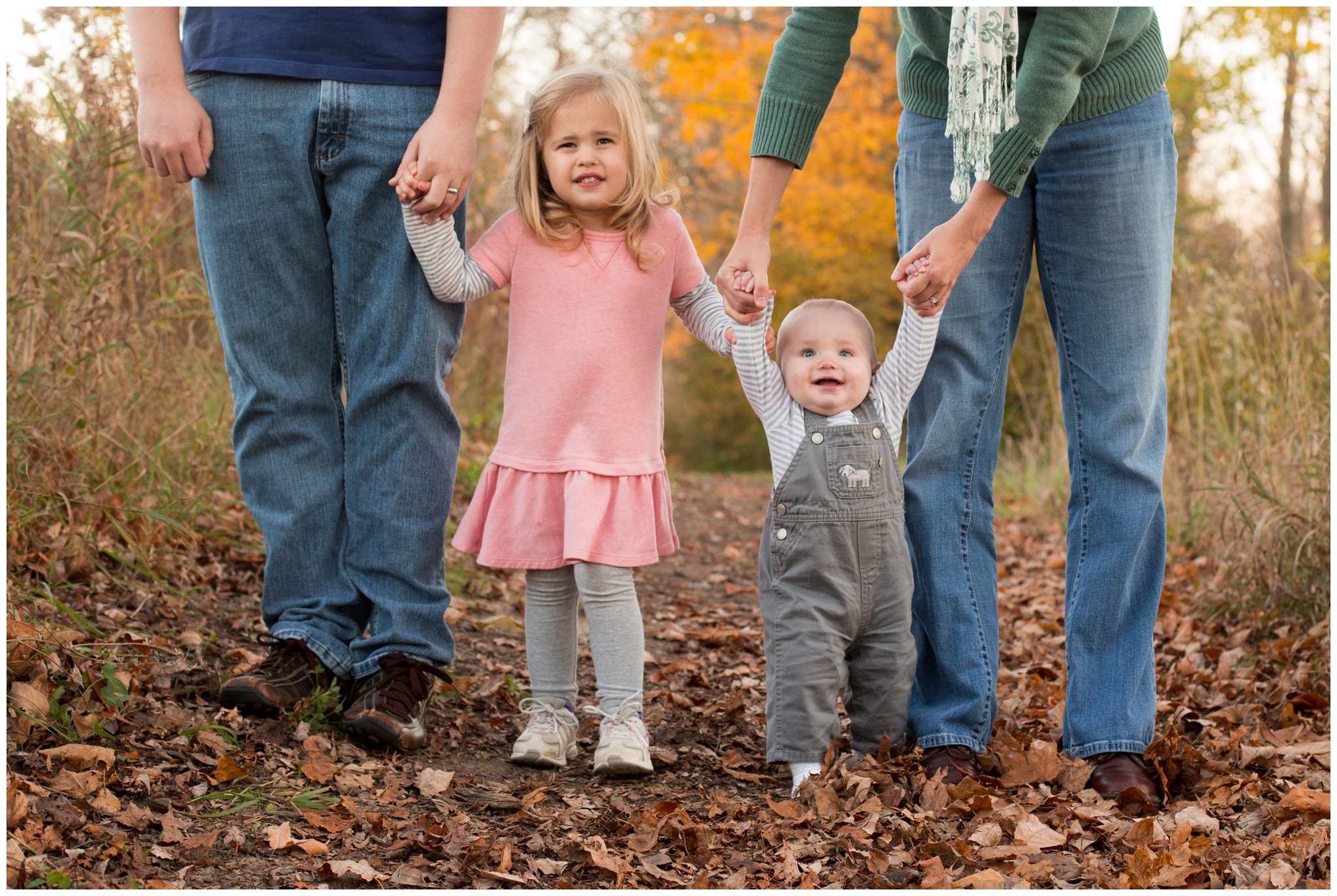 children holding hands during family portraits in Kokomo, Indiana