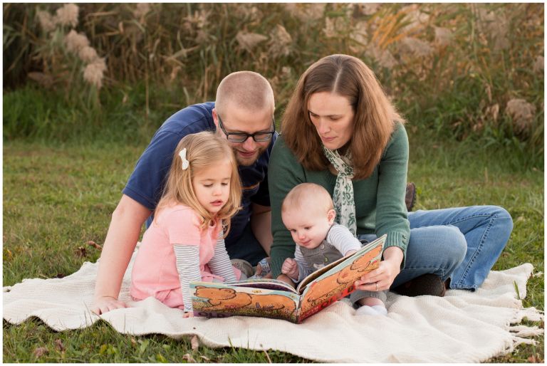 family reading together during family portraits in Kokomo, Indiana