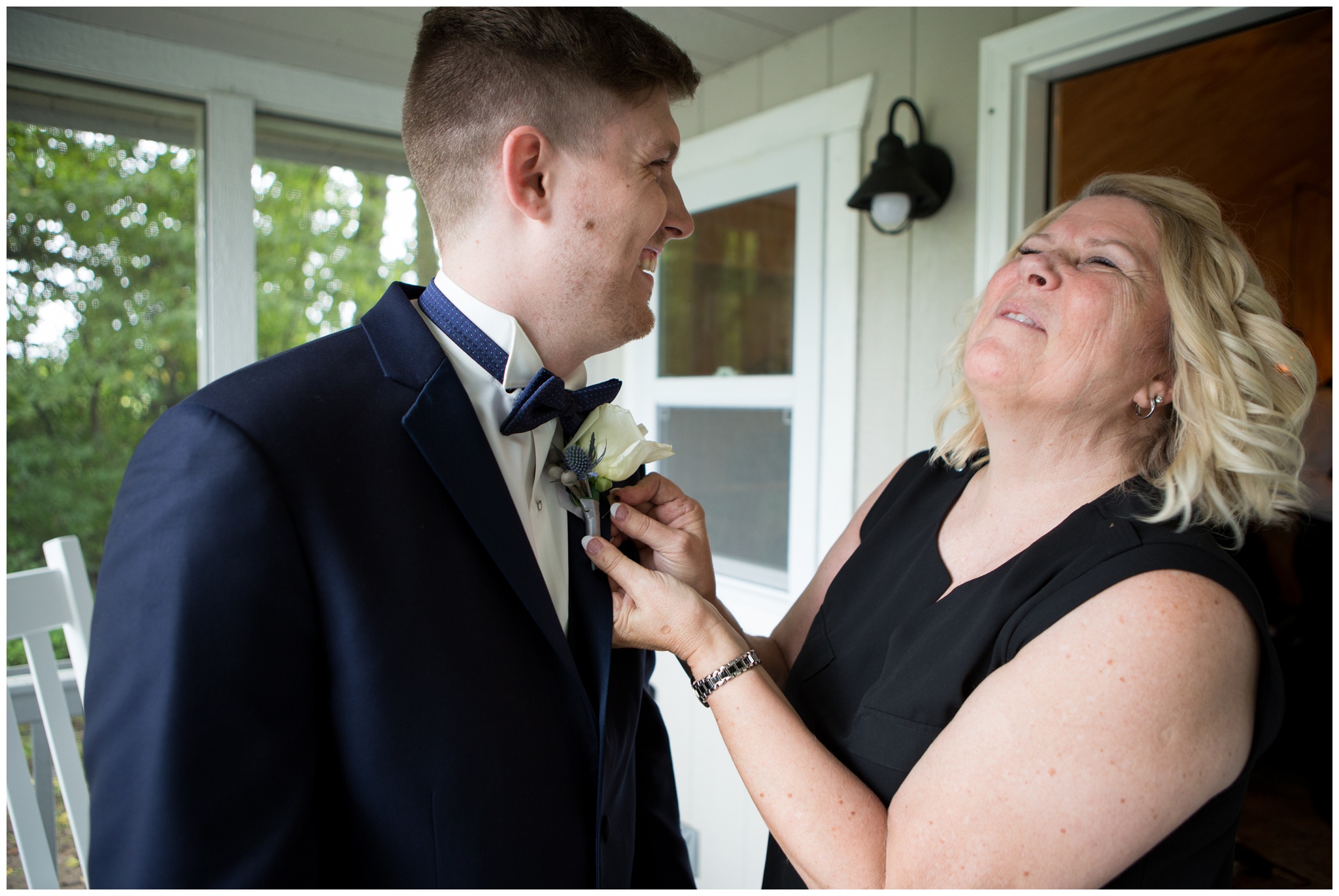 groom's mom pinning on boutonniere at The Lodge at River Valley Farm in Yorktown Indiana