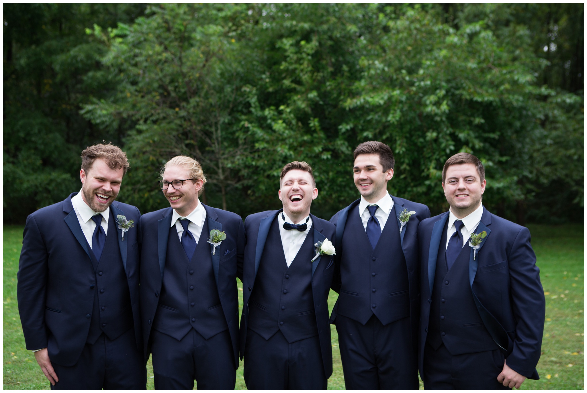 groom and groomsmen laughing during portraits at The Lodge at River Valley Farm in Yorktown Indiana