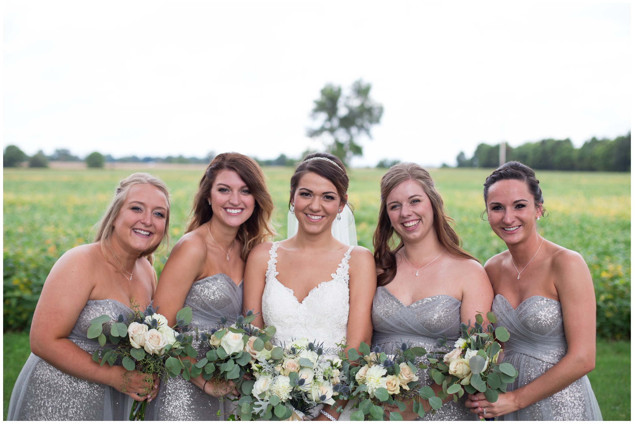 bride with bridesmaids for portraits at the Lodge at River Valley Farm in Yorktown Indiana