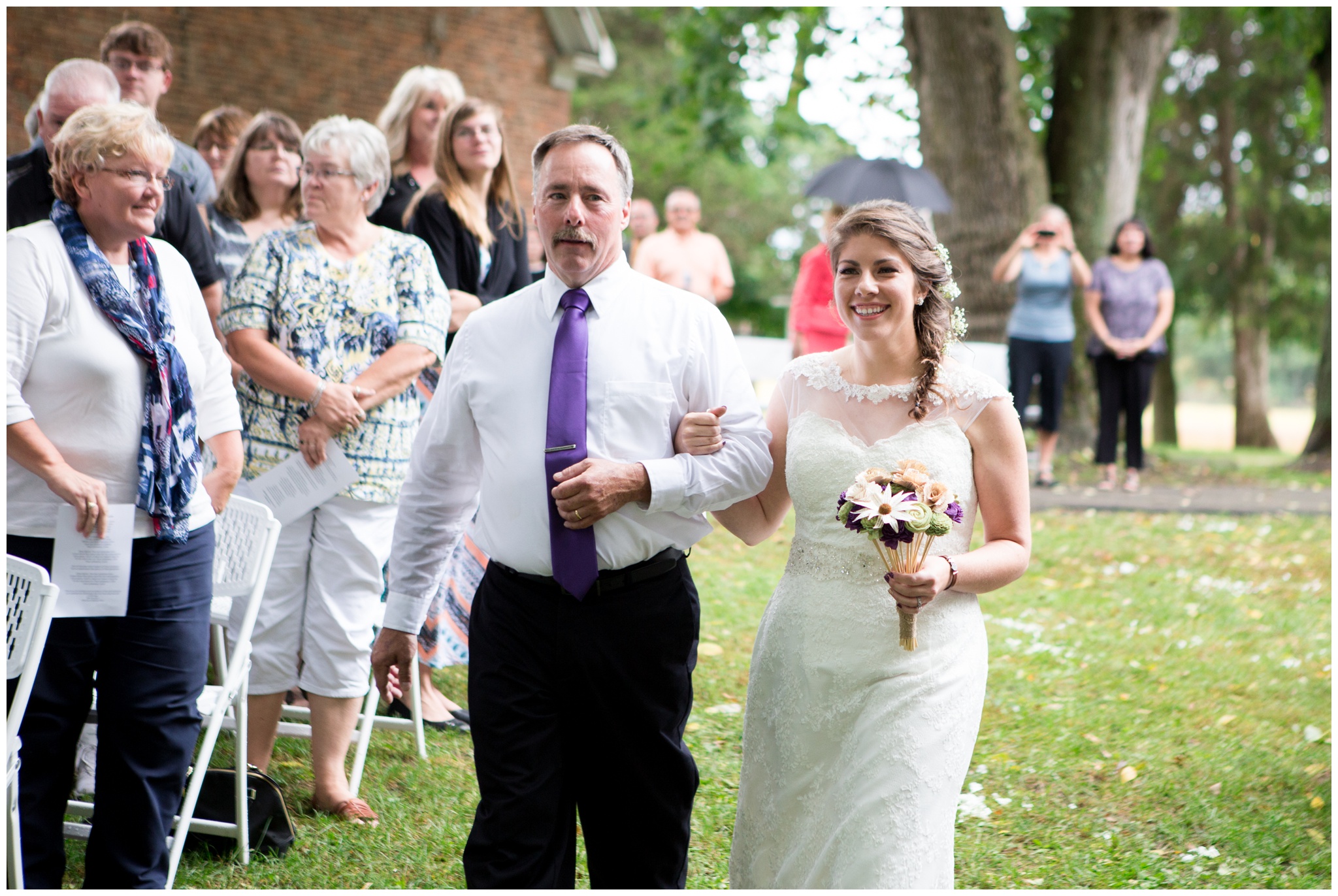 bride walking down aisle with father during ceremony at Historic Meeting House at New Garden in Fountain City Indiana