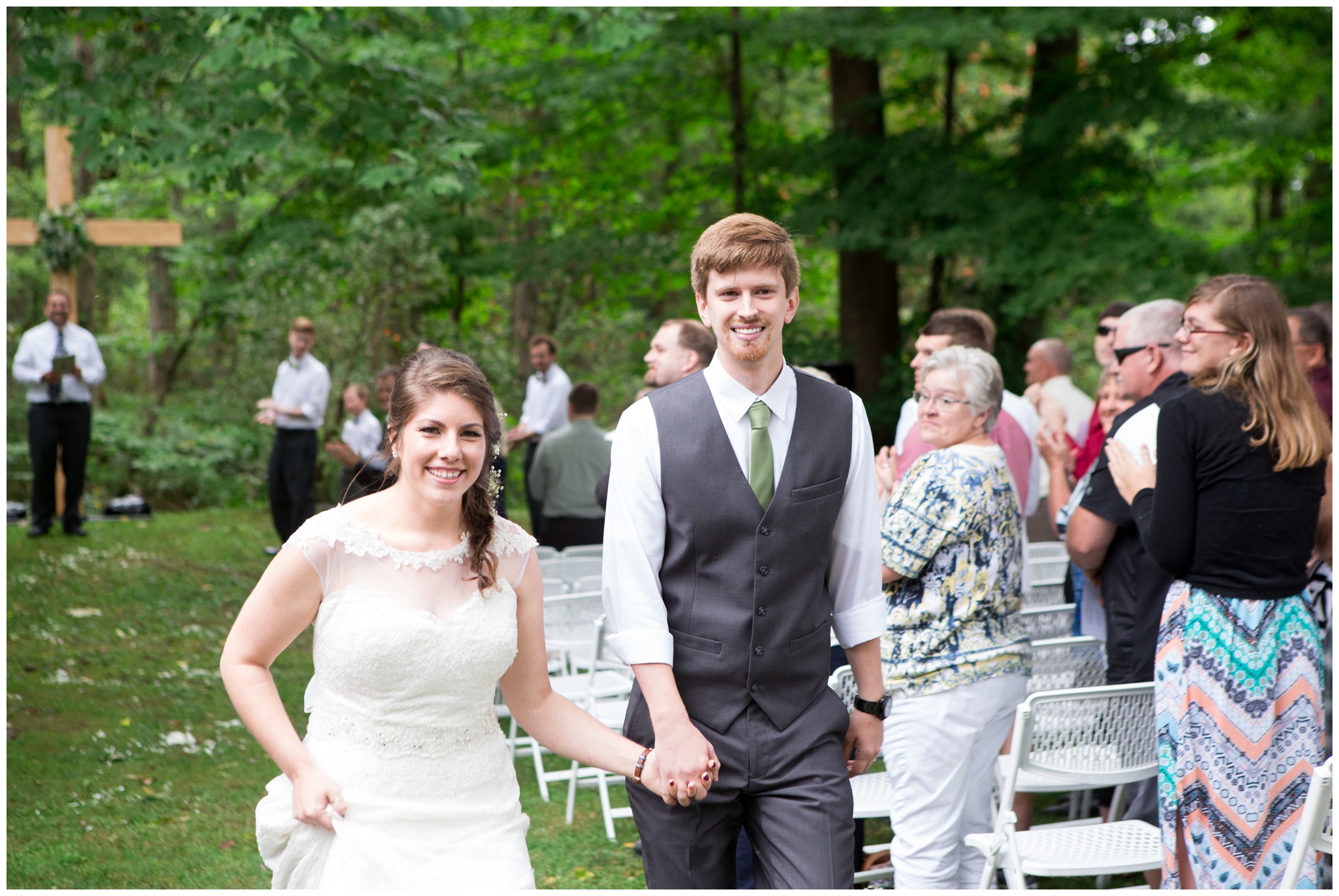 bride and groom walking down aisle after ceremony atHistoric Meeting House at New Garden in Fountain City Indiana