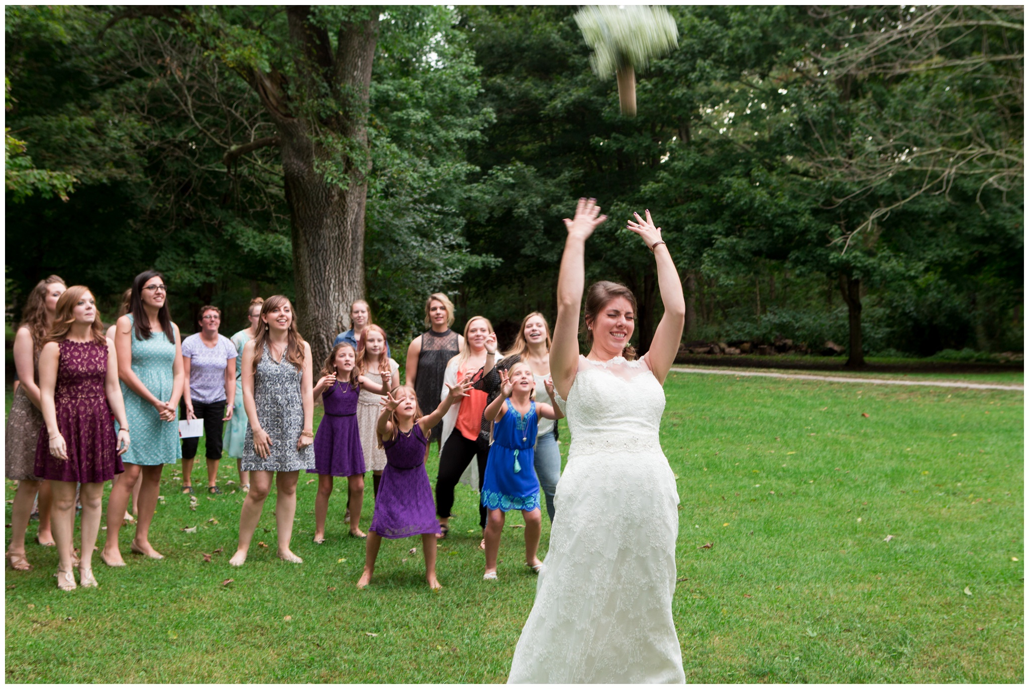 bride tossing bouquet at reception at Historic Meeting House at New Garden in Fountain City Indiana