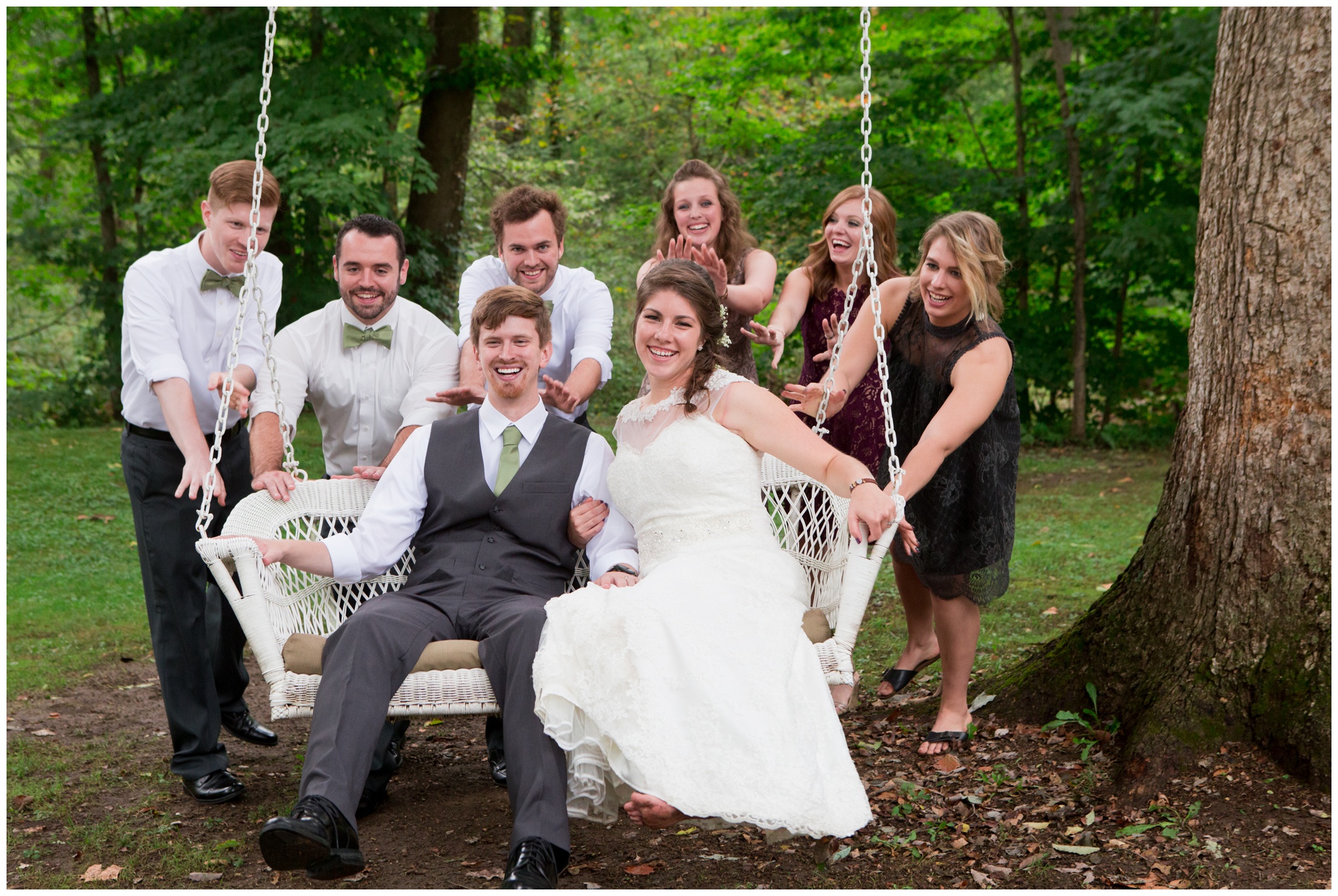 bridal party pushing couple on swing at Historic Meeting House at New Garden in Fountain City Indiana