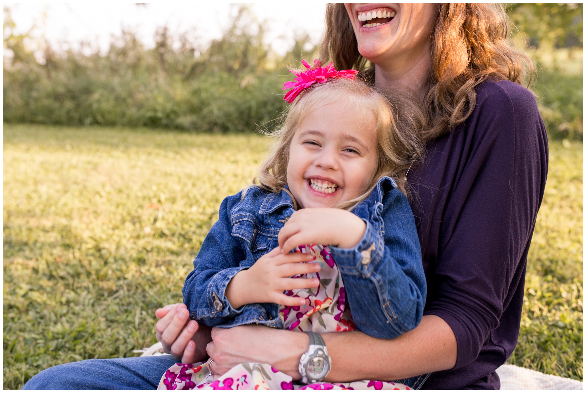 daughter on mom's lap laughing at Wildcat Creek Reservoir Park in Kokomo Indiana