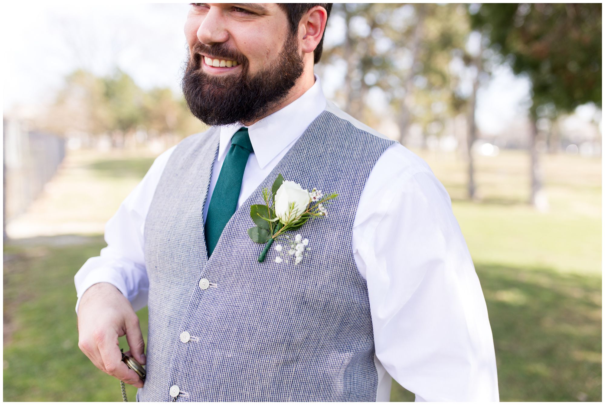 groom holding pocket watch before wedding at Garfield Park Conservatory in Indianapolis