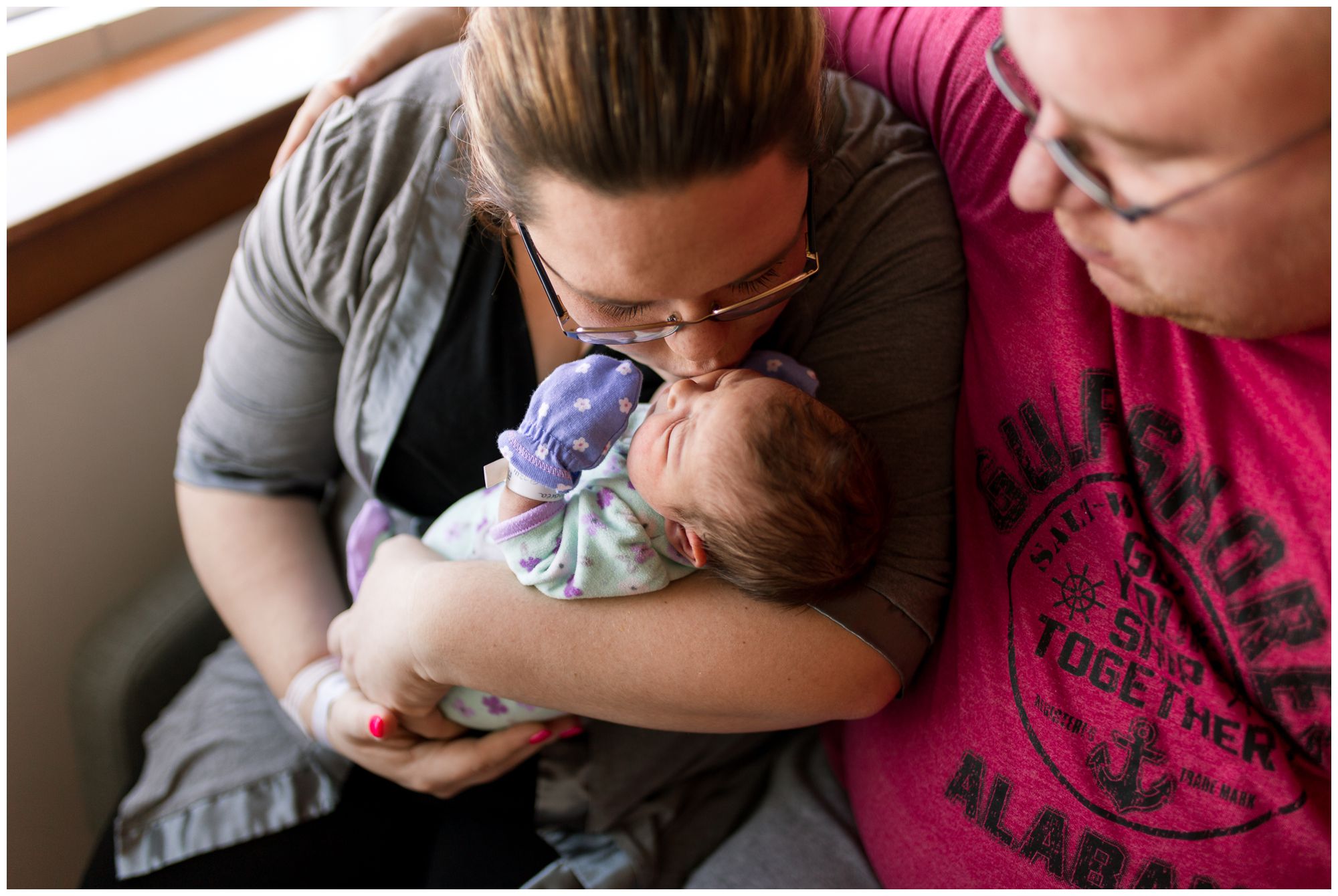 mom giving kisses to baby during Kokomo Indiana newborn session at Community Howard Regional Health