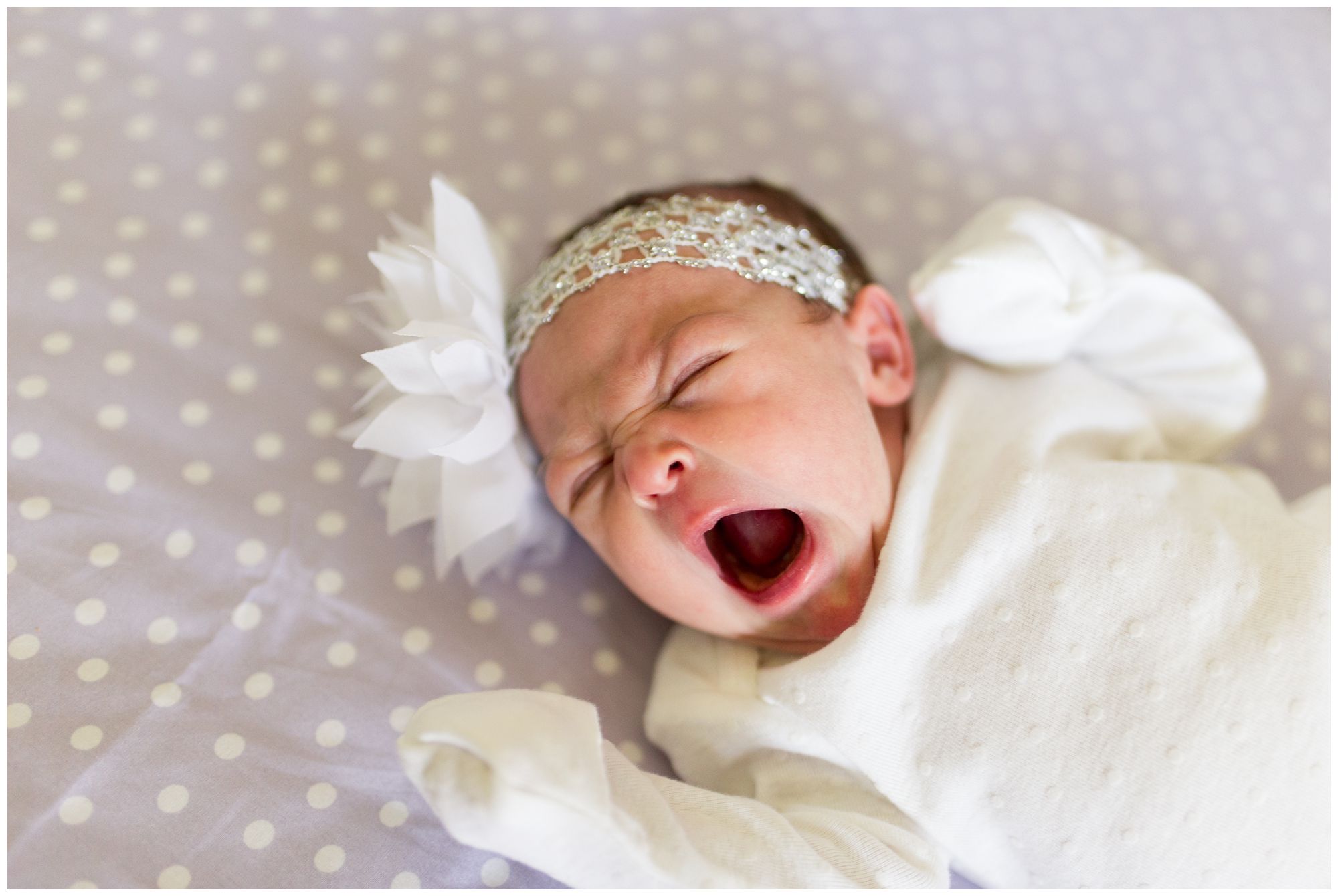 newborn Charlotte yawning during session