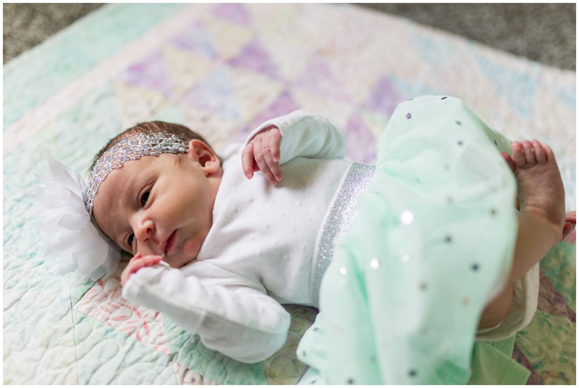 newborn lying on handmade quilt during newborn session in Kokomo Indiana