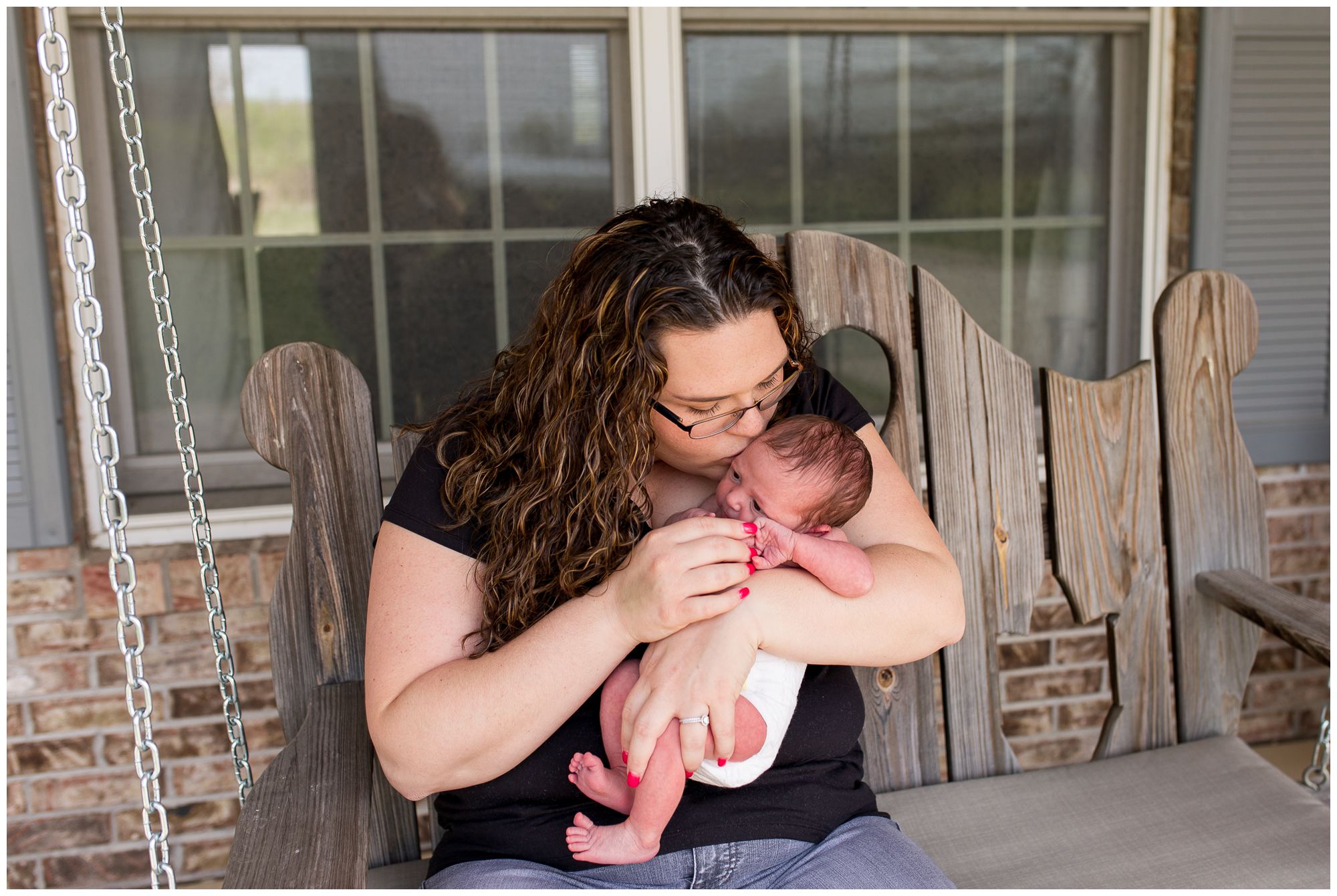 mom kisses baby's face during newborn session in Kokomo Indiana