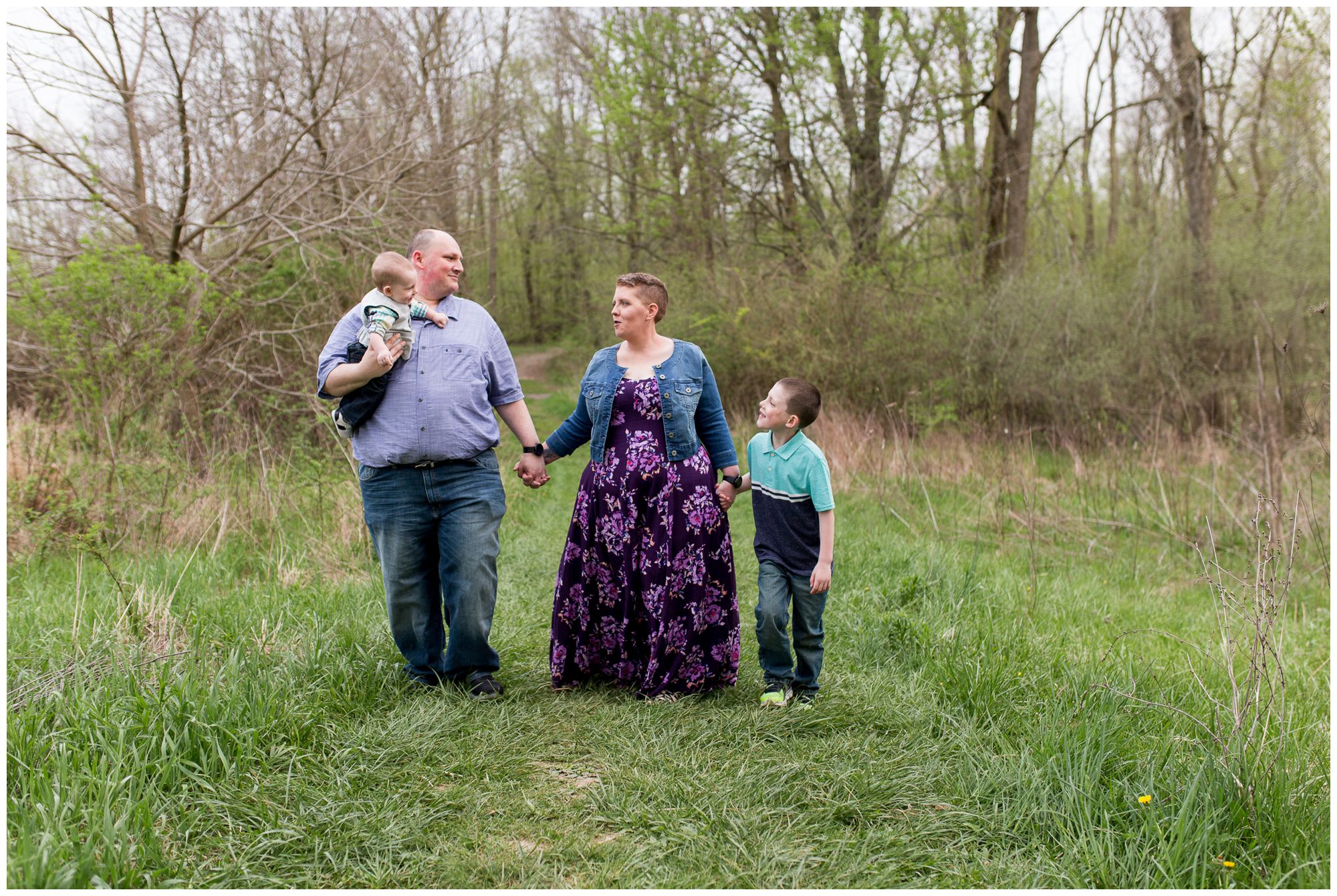 family holds hands and walks together during Kokomo Reservoir family session