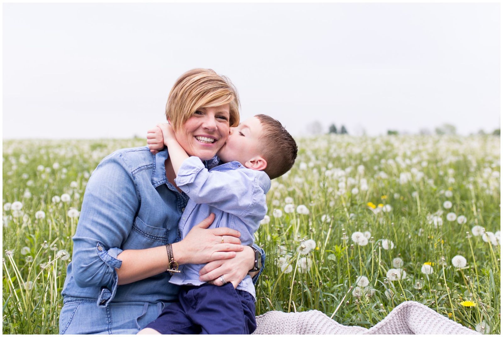 mom and son in field of dandelions at Wildkat Creek Reservoir Park in Kokomo Indiana