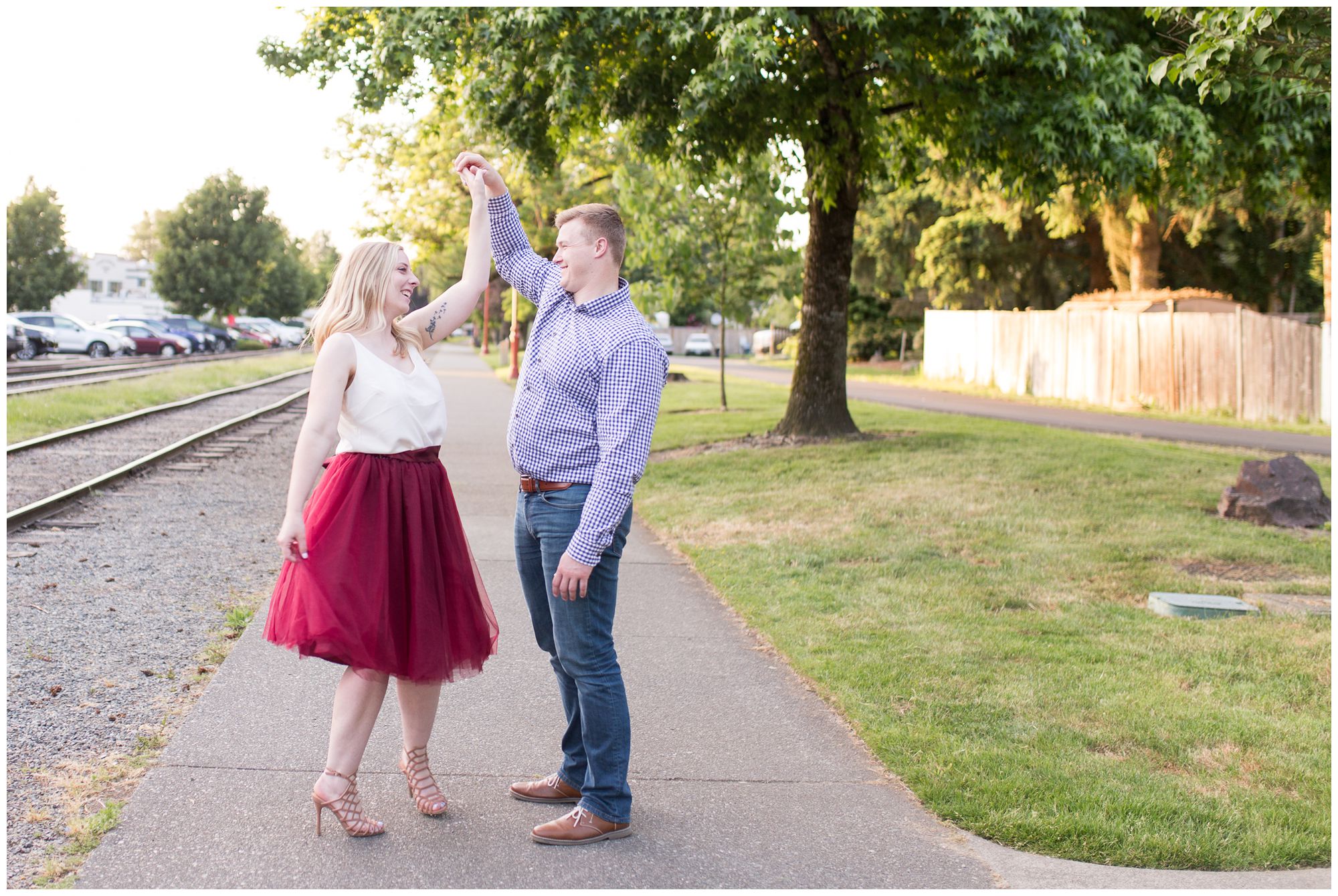 groom twirls bride during Issaquah engagement session at Issaquah Depot Museum // Autumn Howell Photography