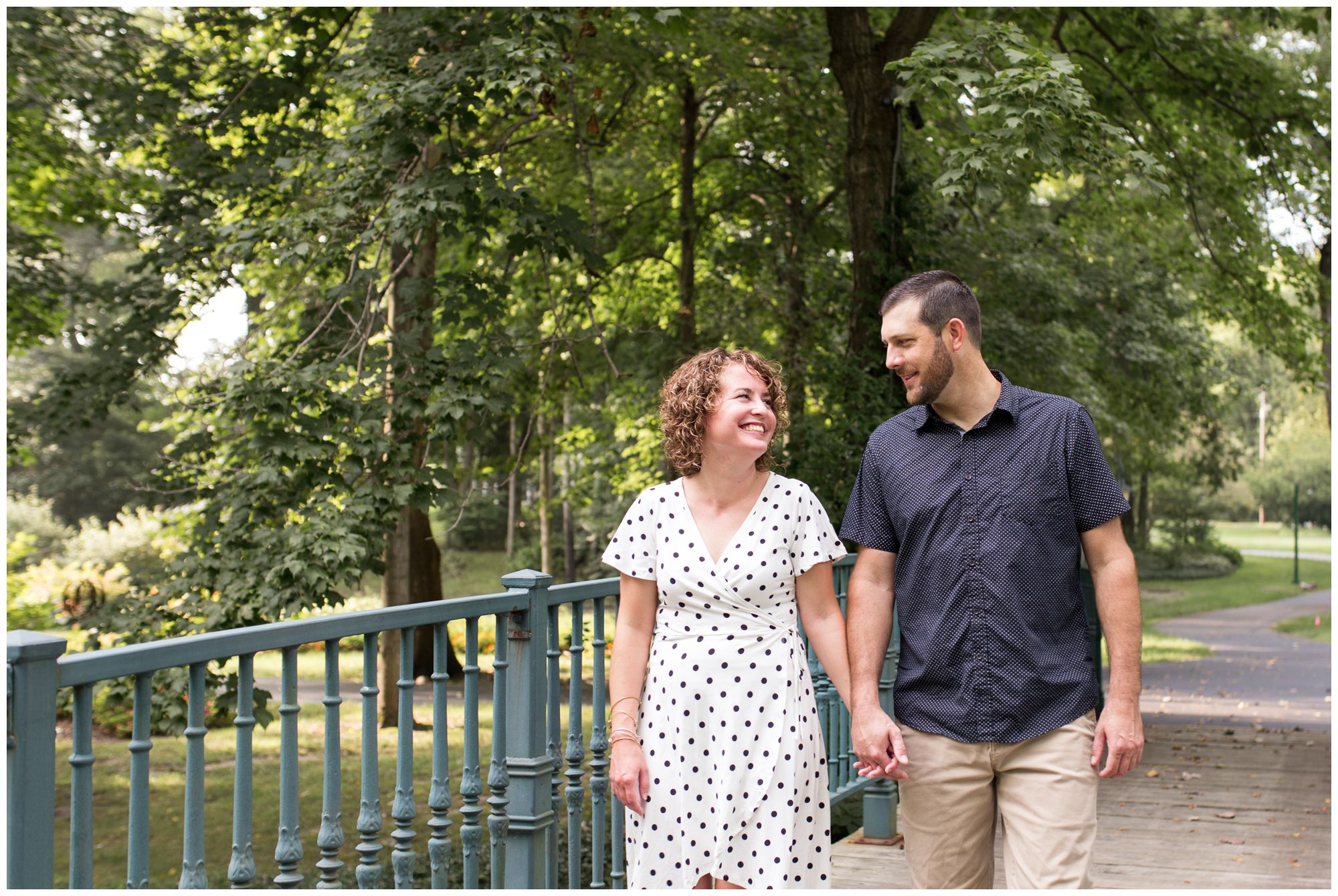 bride and groom hold hands and walk at Charley Creek Gardens during Wabash Indiana engagement session