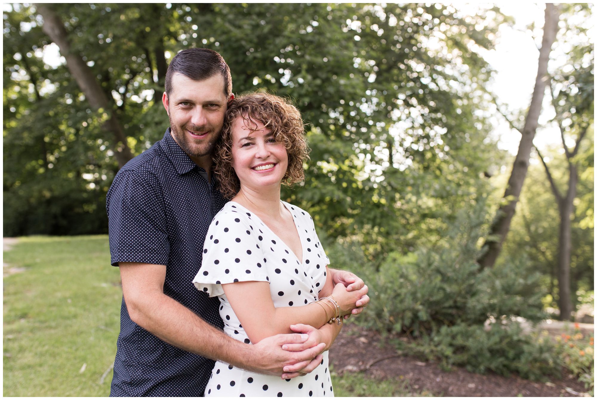 groom wraps arms around bride during Charley Creek Gardens engagement session in Wabash, Indiana
