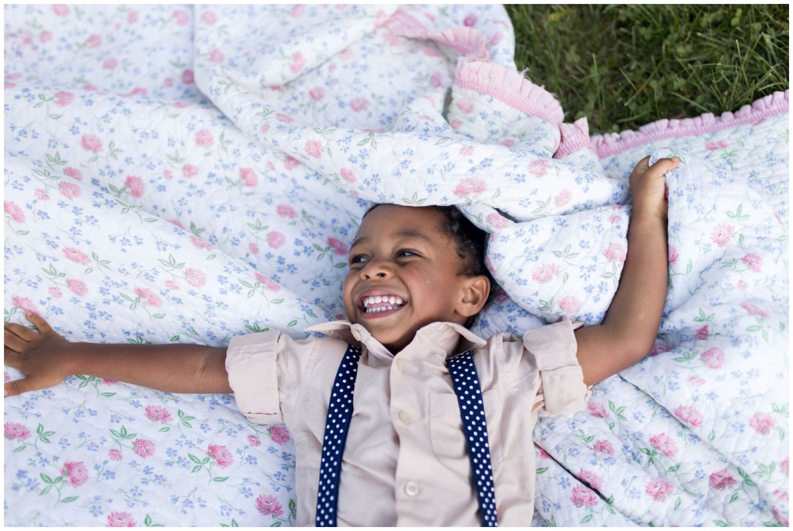 son gives cheesy smile lying on blanket at Jackson Morrow Park during Kokomo family session