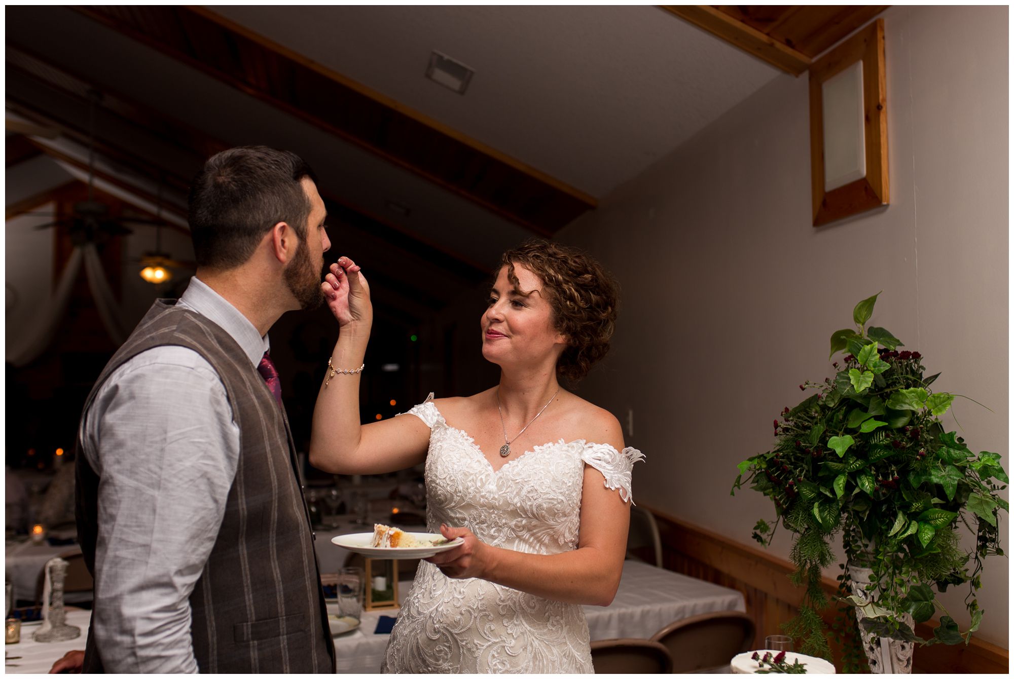 bride feeds groom cake during Peru Indiana wedding reception