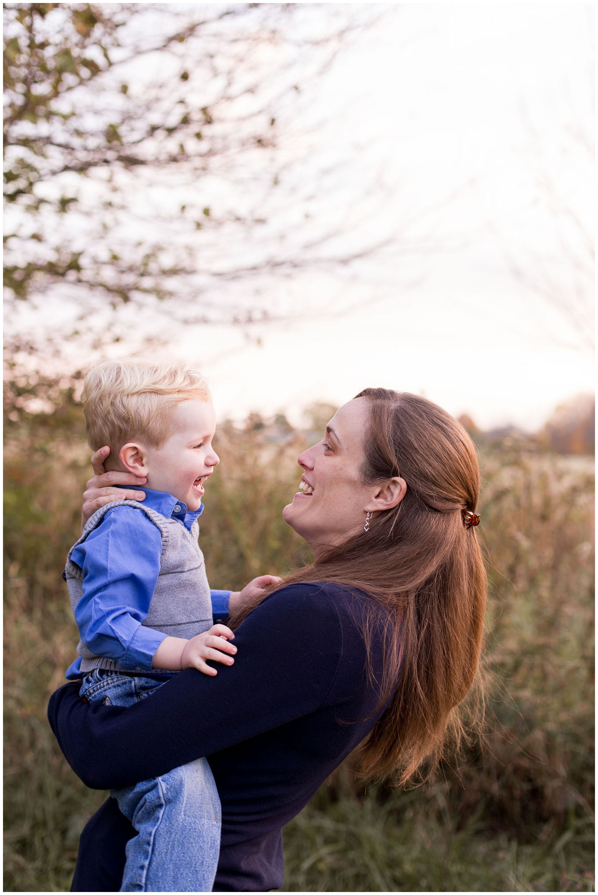 mom looks at son and smiles during family session in Kokomo Indiana