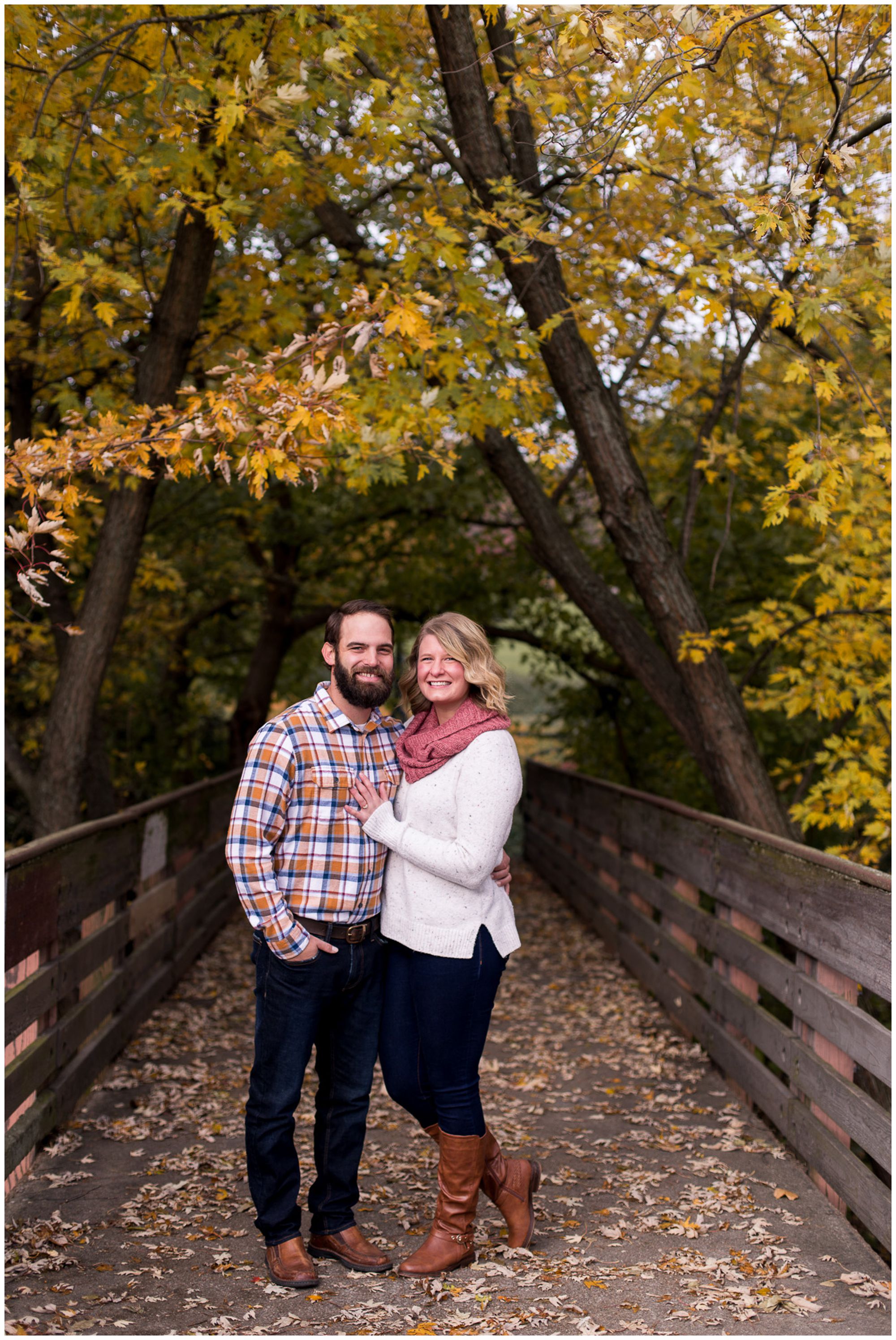 bride and groom on Headwaters Park bridge during Fort Wayne fall engagement session