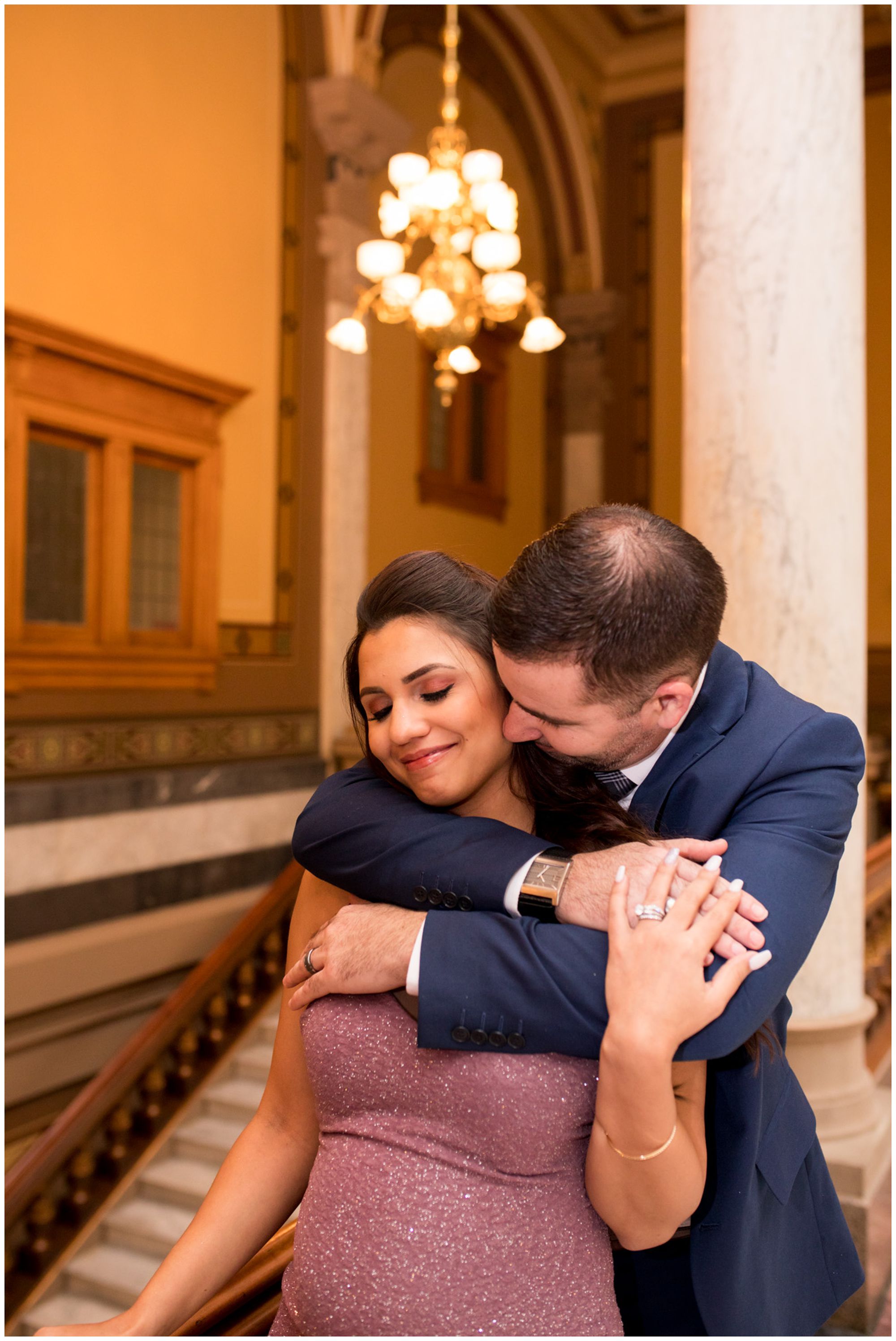 groom gives bride hug from behind after Indiana Statehouse elopement ceremony