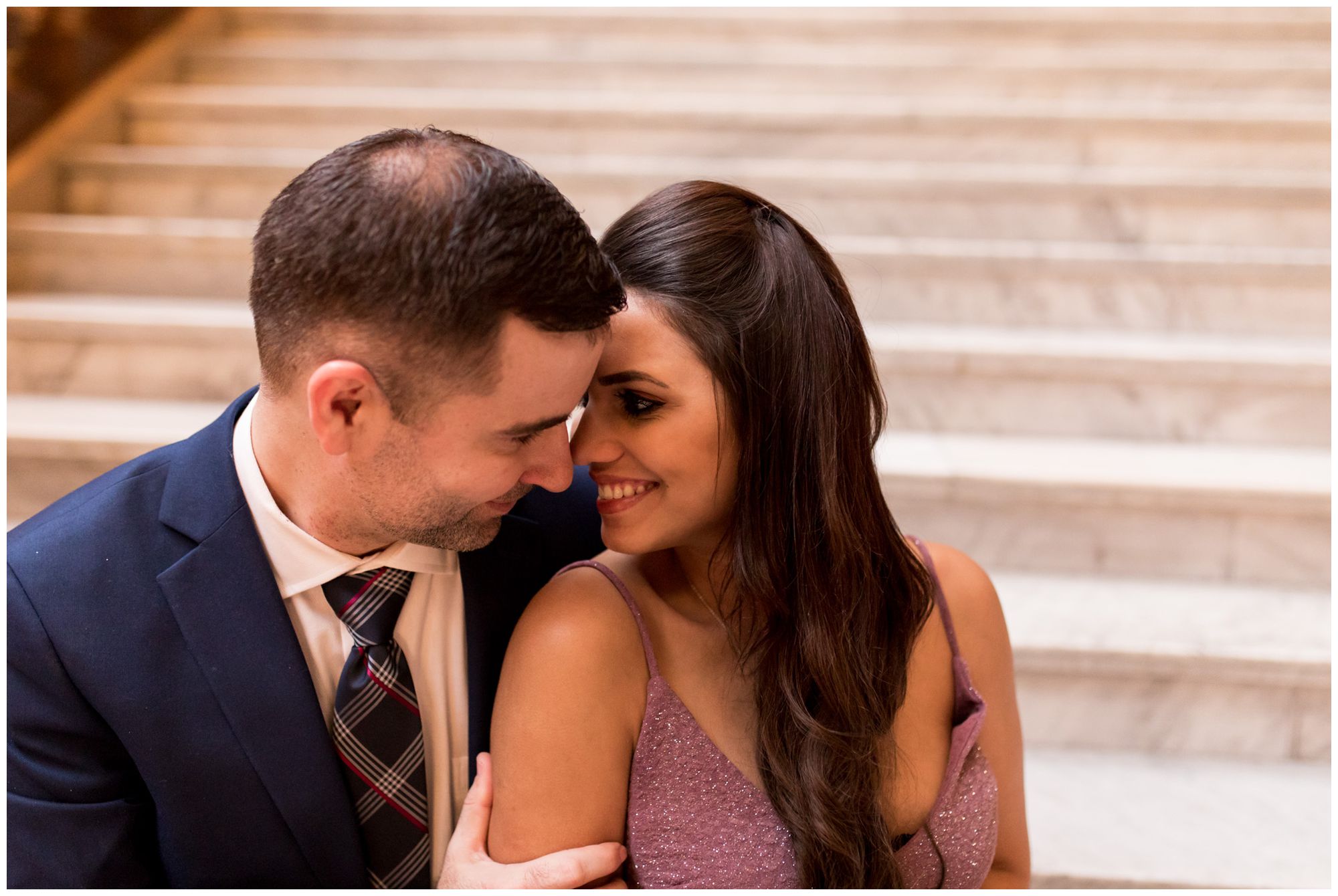 bride and groom snuggle on steps in Indiana Statehouse after downtown Indianapolis elopement