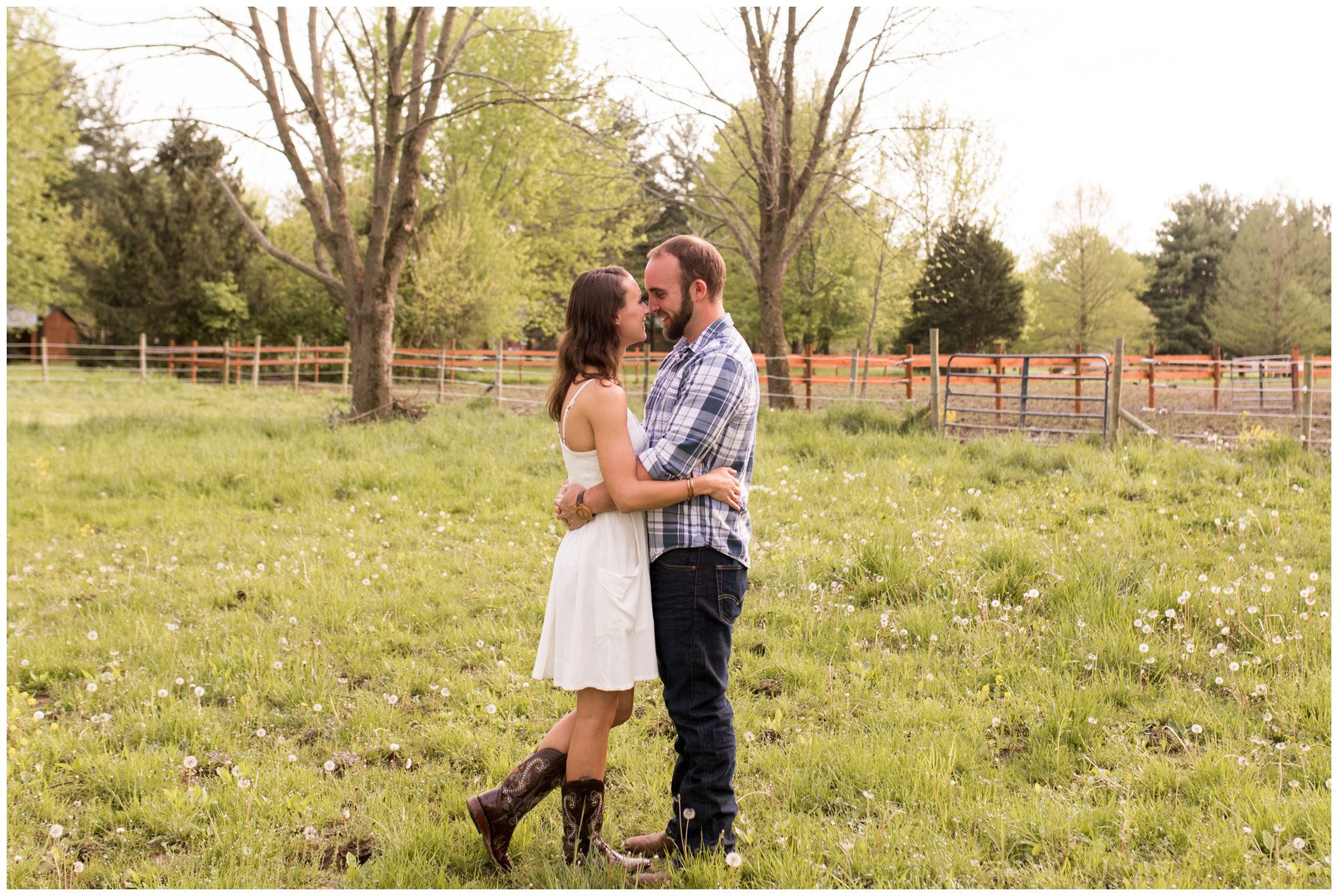 bride and groom kiss in horse pasture during Indianapolis engagement session