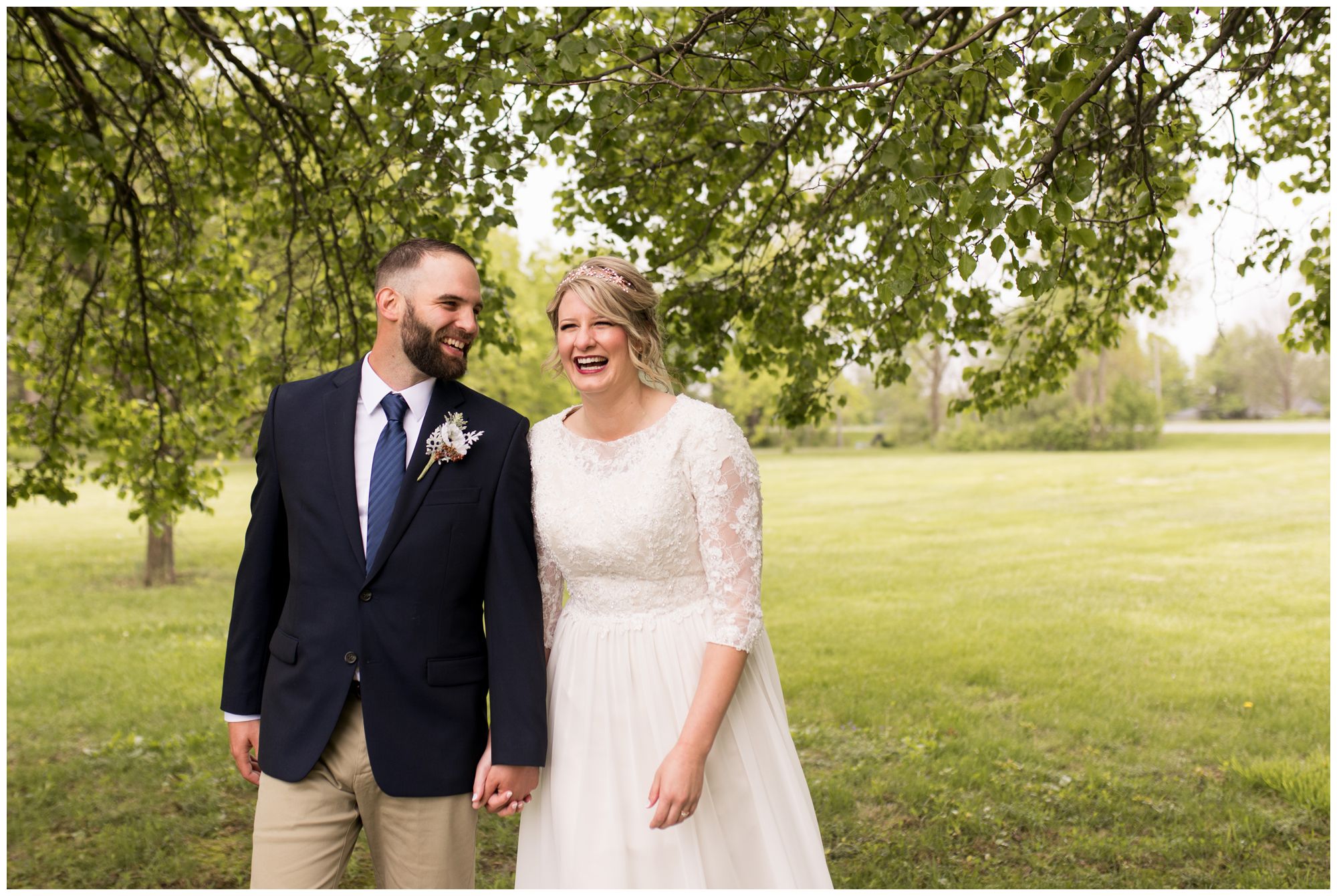 bride and groom walk and laugh together during portraits after wedding ceremony in Muncie Indiana