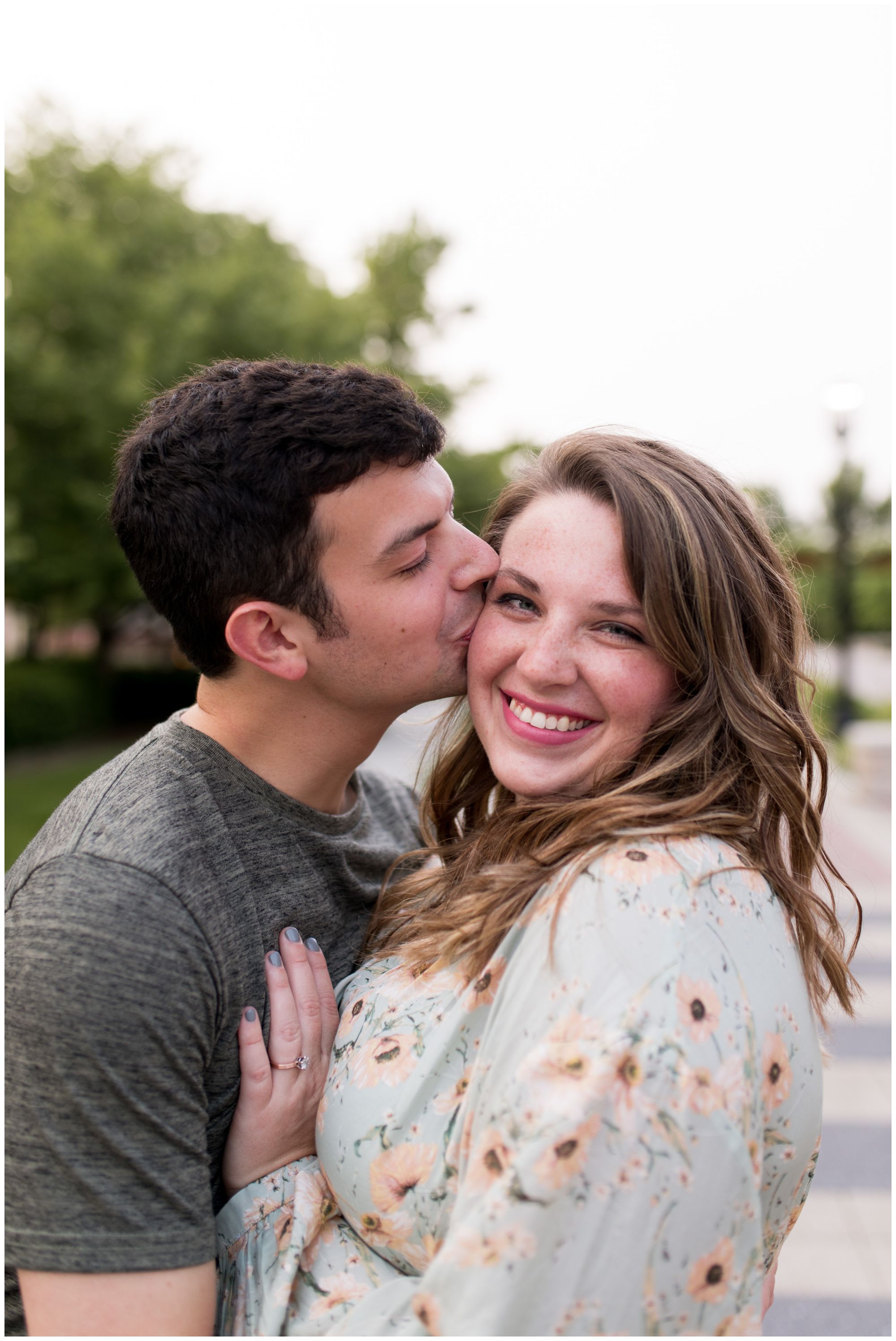 groom kisses bride on cheek during Purdue University engagement session in West Lafayette Indiana