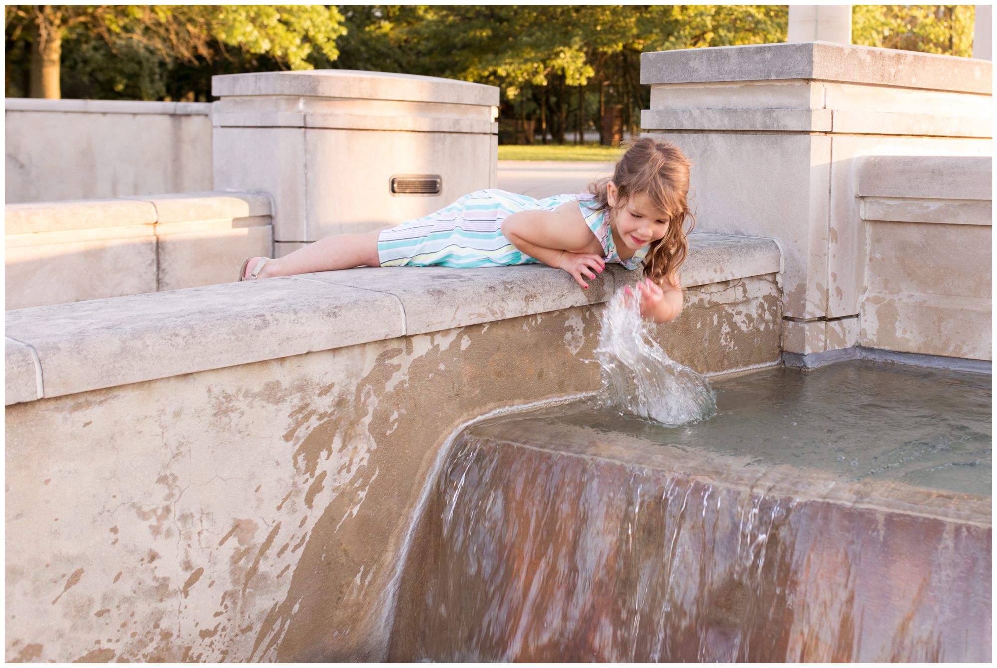 girl splashing in fountain at Coxhall Gardens in Carmel, Indiana