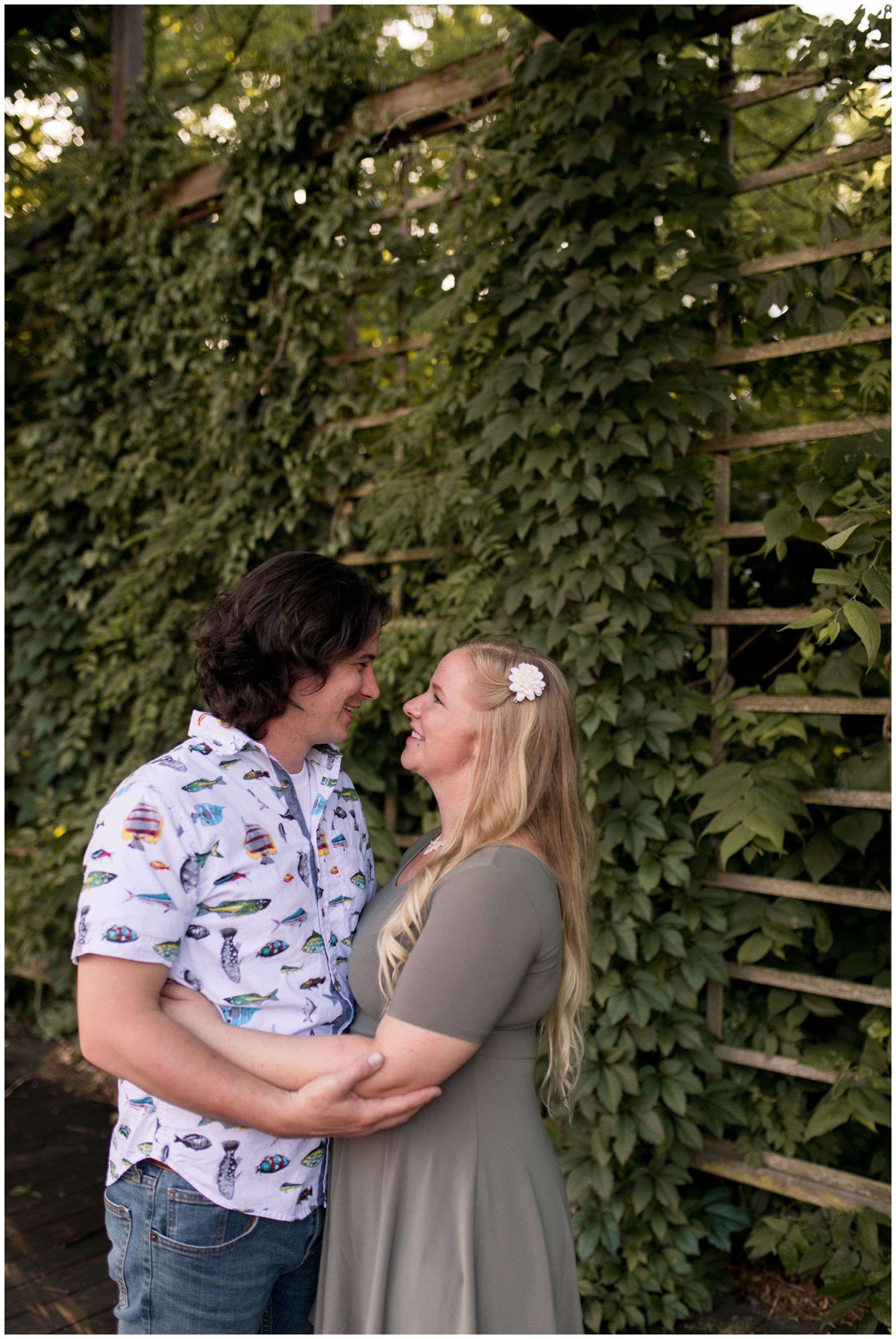 couple holds each other during engagement session at Indianapolis Art Center