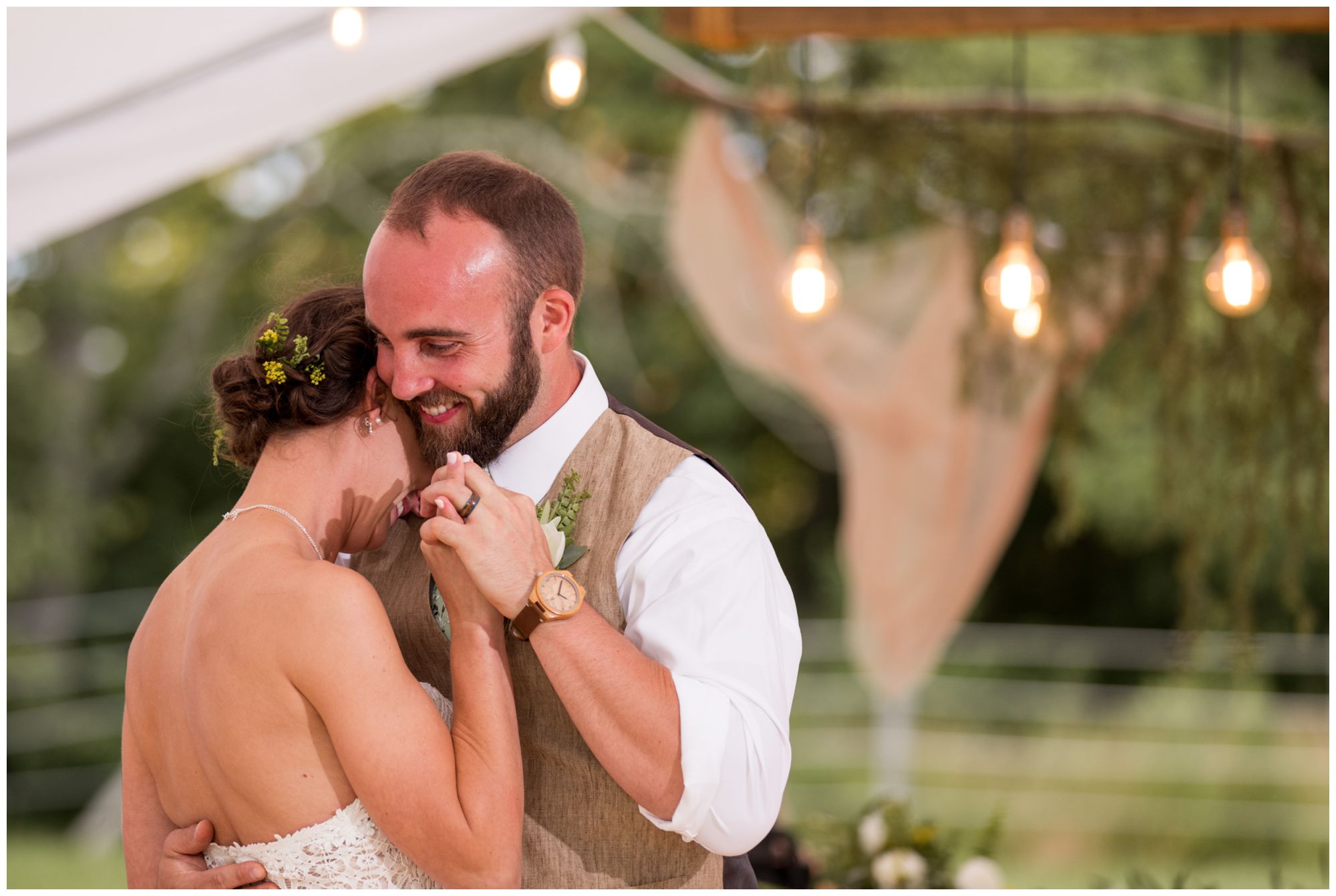 bride and groom share first dance under tent at Indianapolis backyard wedding reception