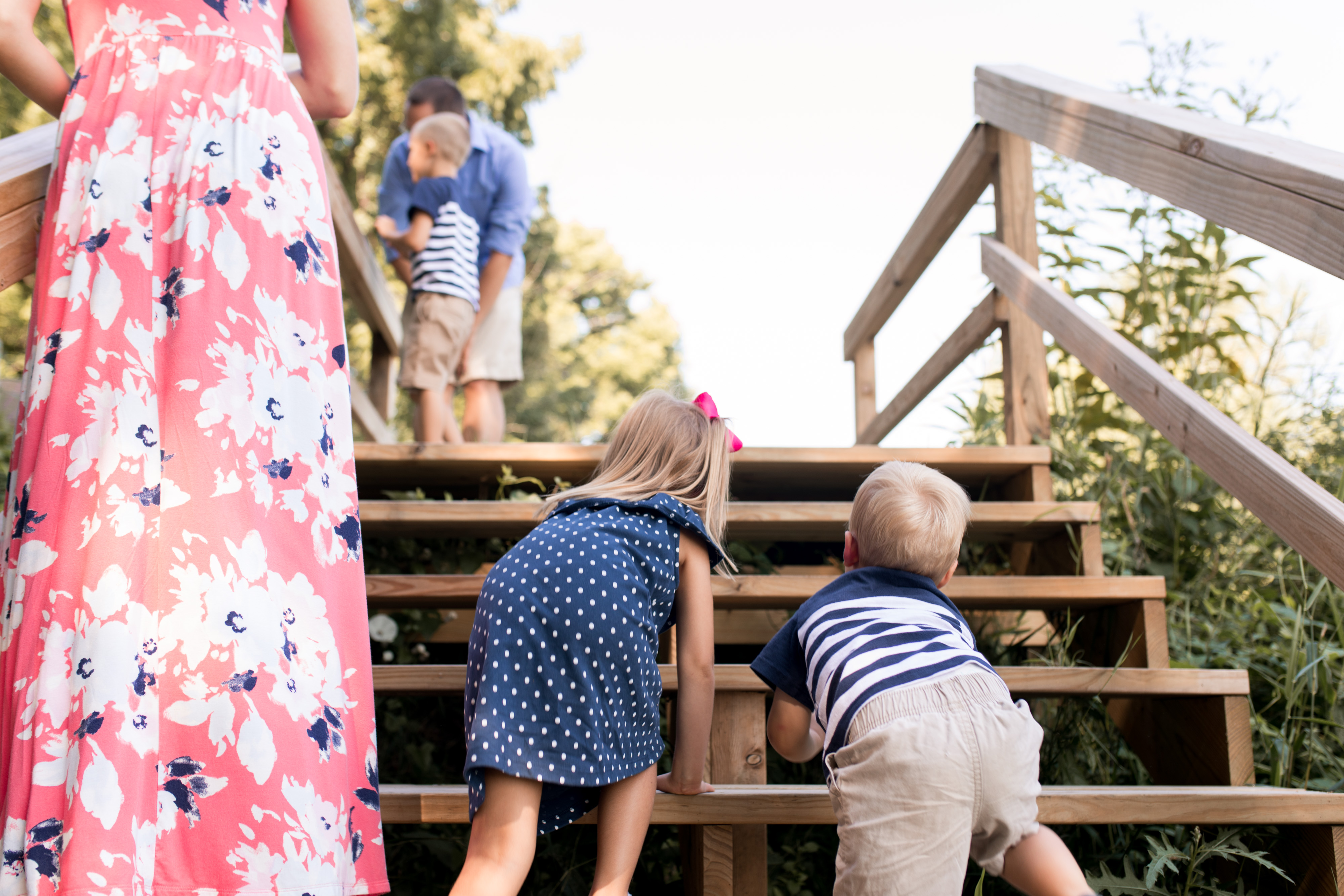 kids climb up stairs during family session at Noblesville park