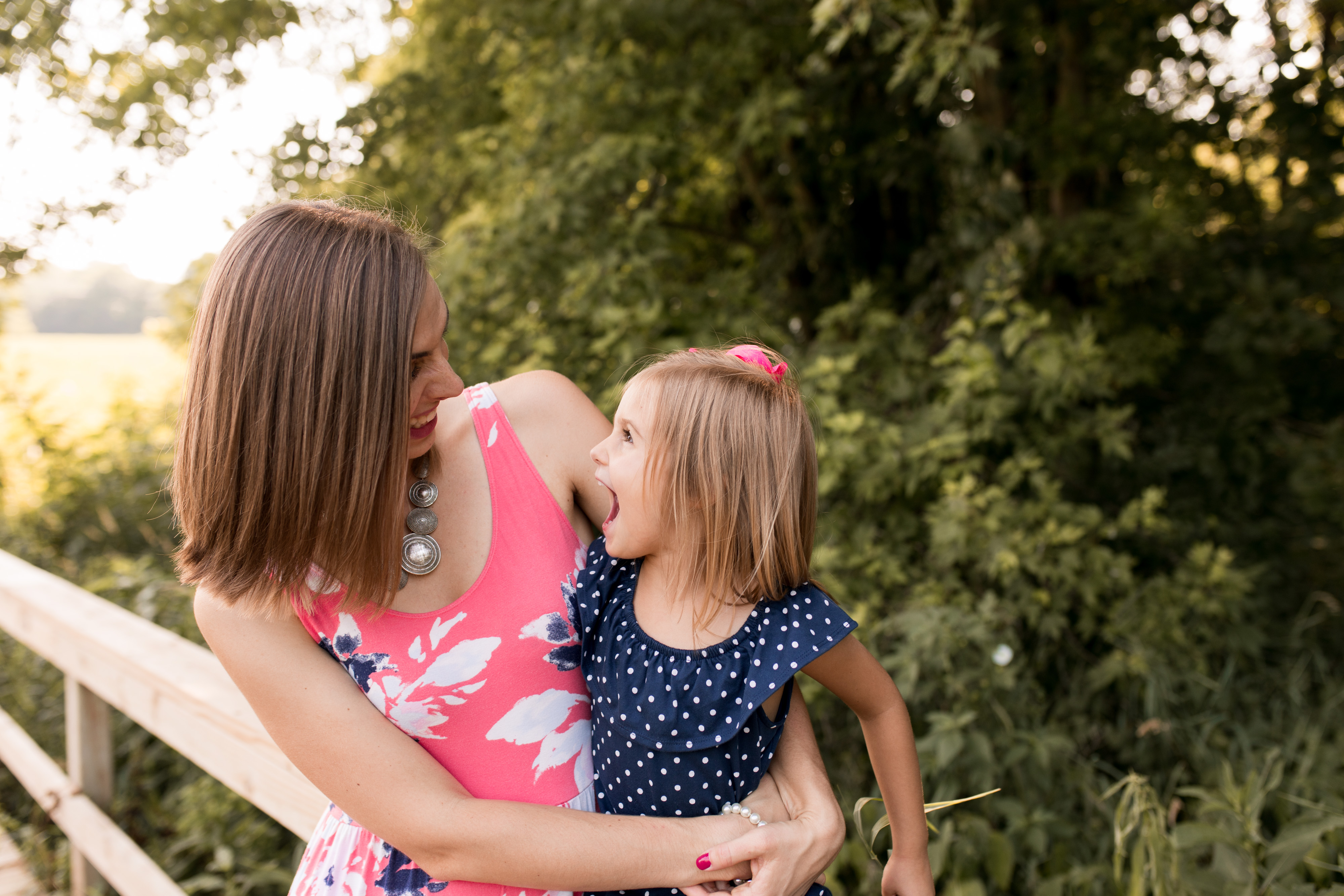 mom and daughter laughing together during family session at Potters Bridge Park in Noblesville Indiana