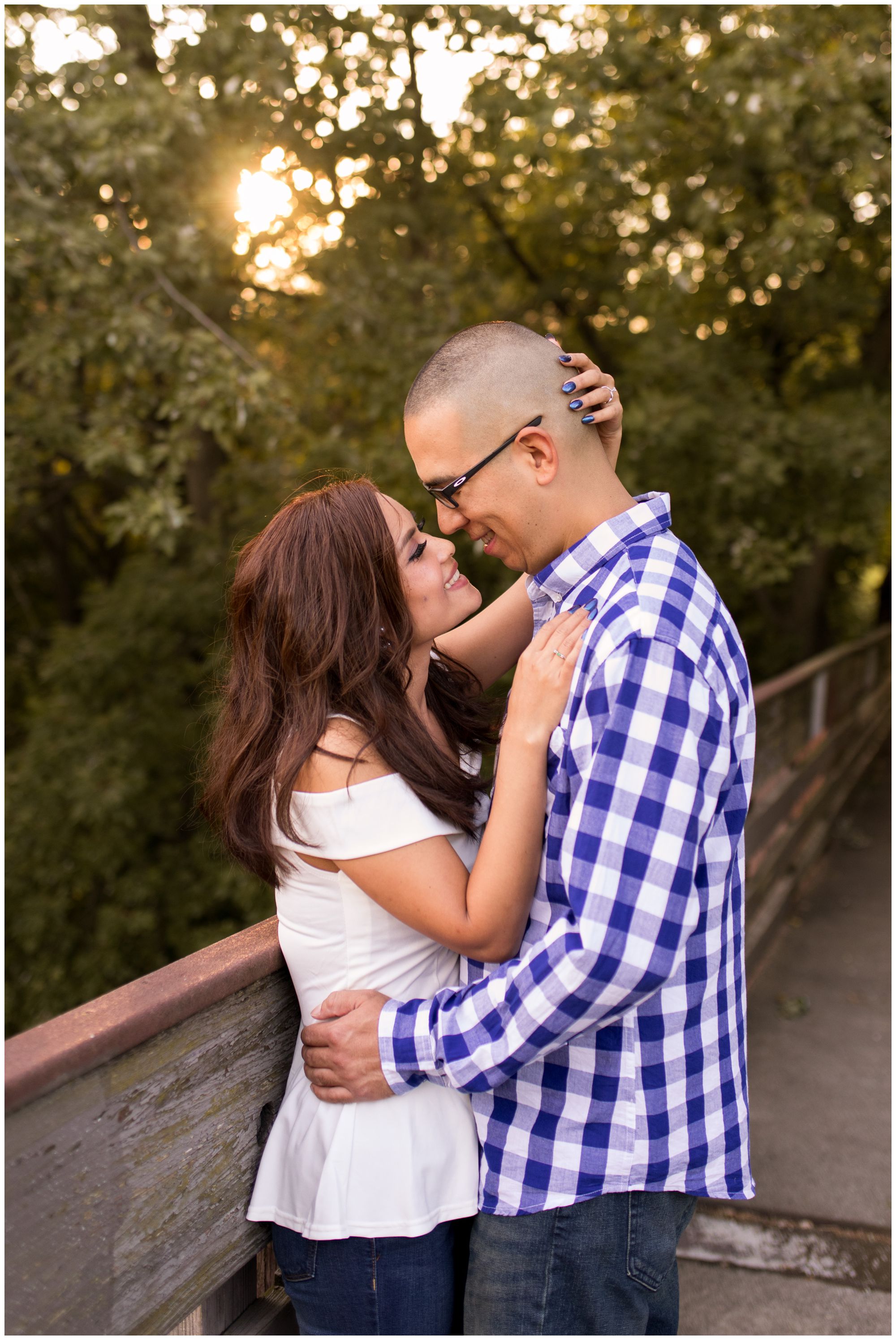 bride and groom smile at each other during engagement session at Headwaters Park