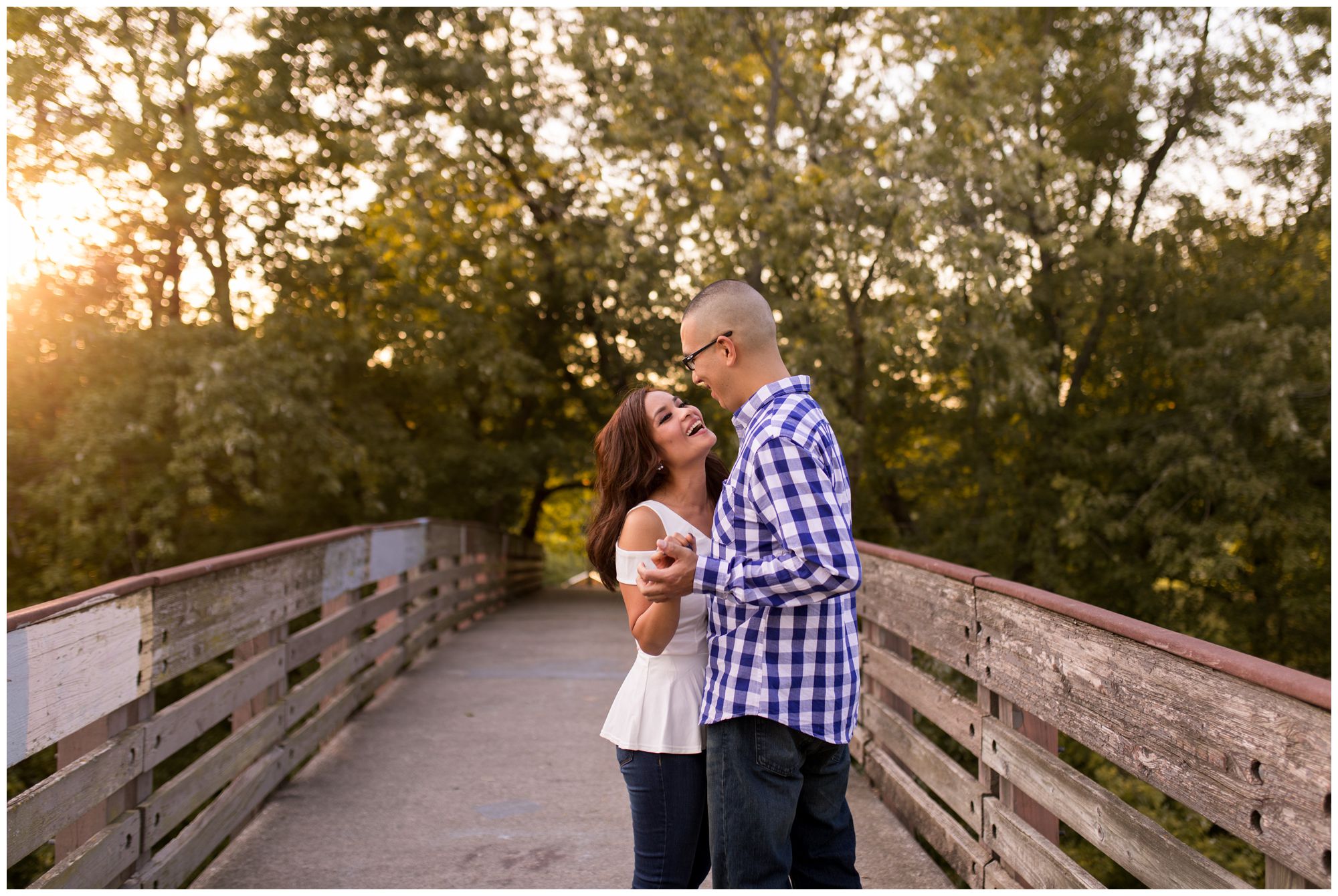 couple dances together on bridge at Headwaters Park engagement session in Fort Wayne Indiana