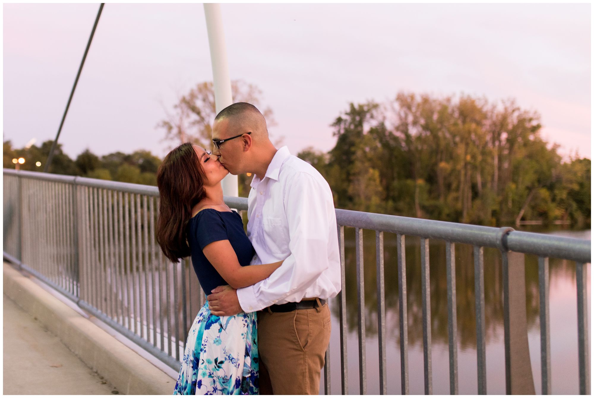 couple kisses on Parker Cole pedestrian bridge in Fort Wayne Indiana