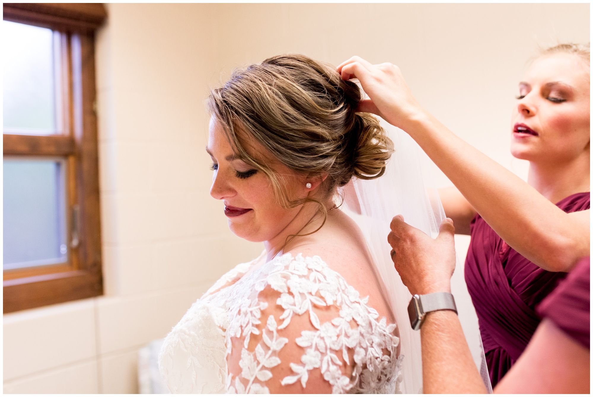 bridemaids put in veil for bride before Decatur Indiana wedding ceremony