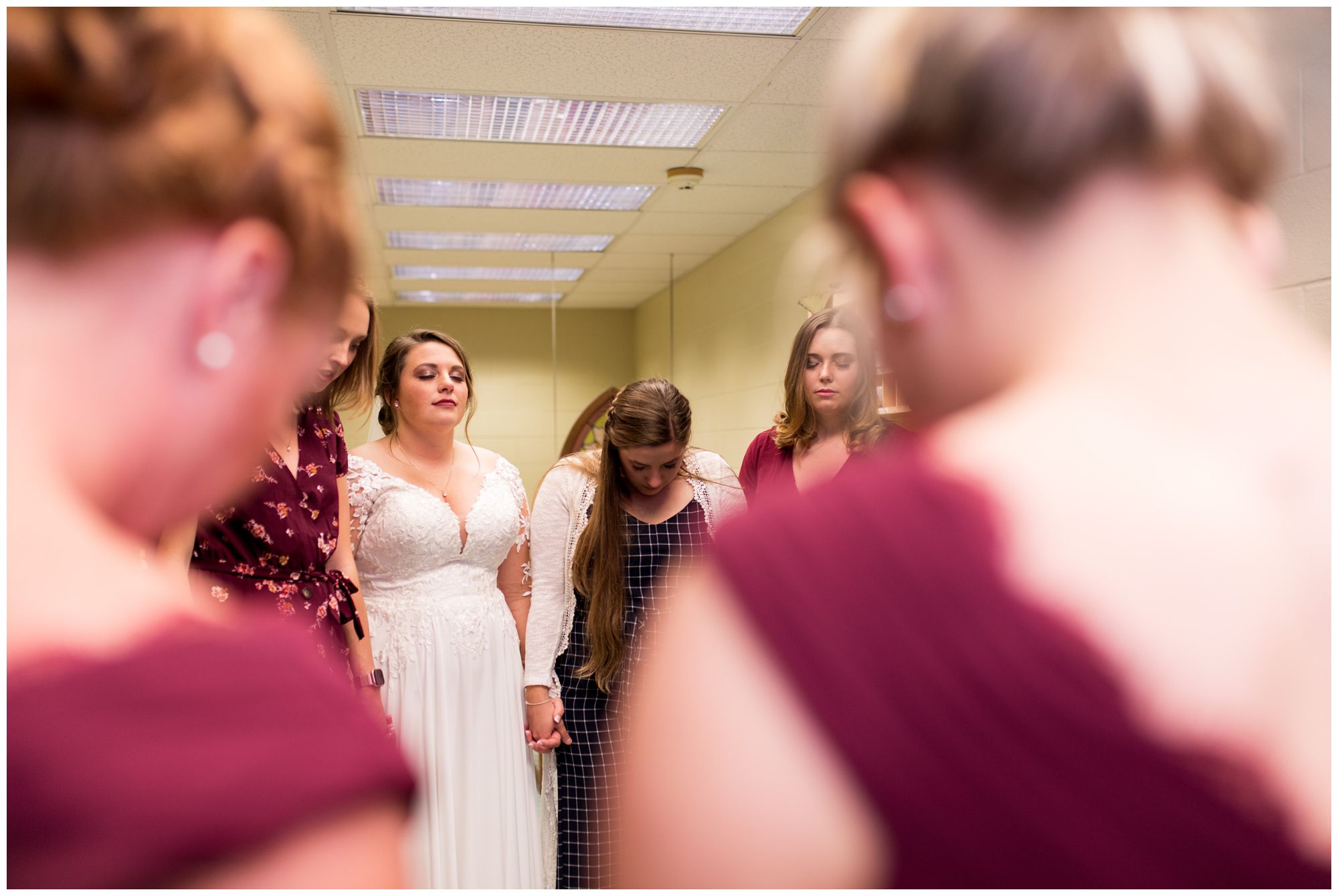 bride praying with friends before wedding ceremony at Zion Lutheran Church in Decatur