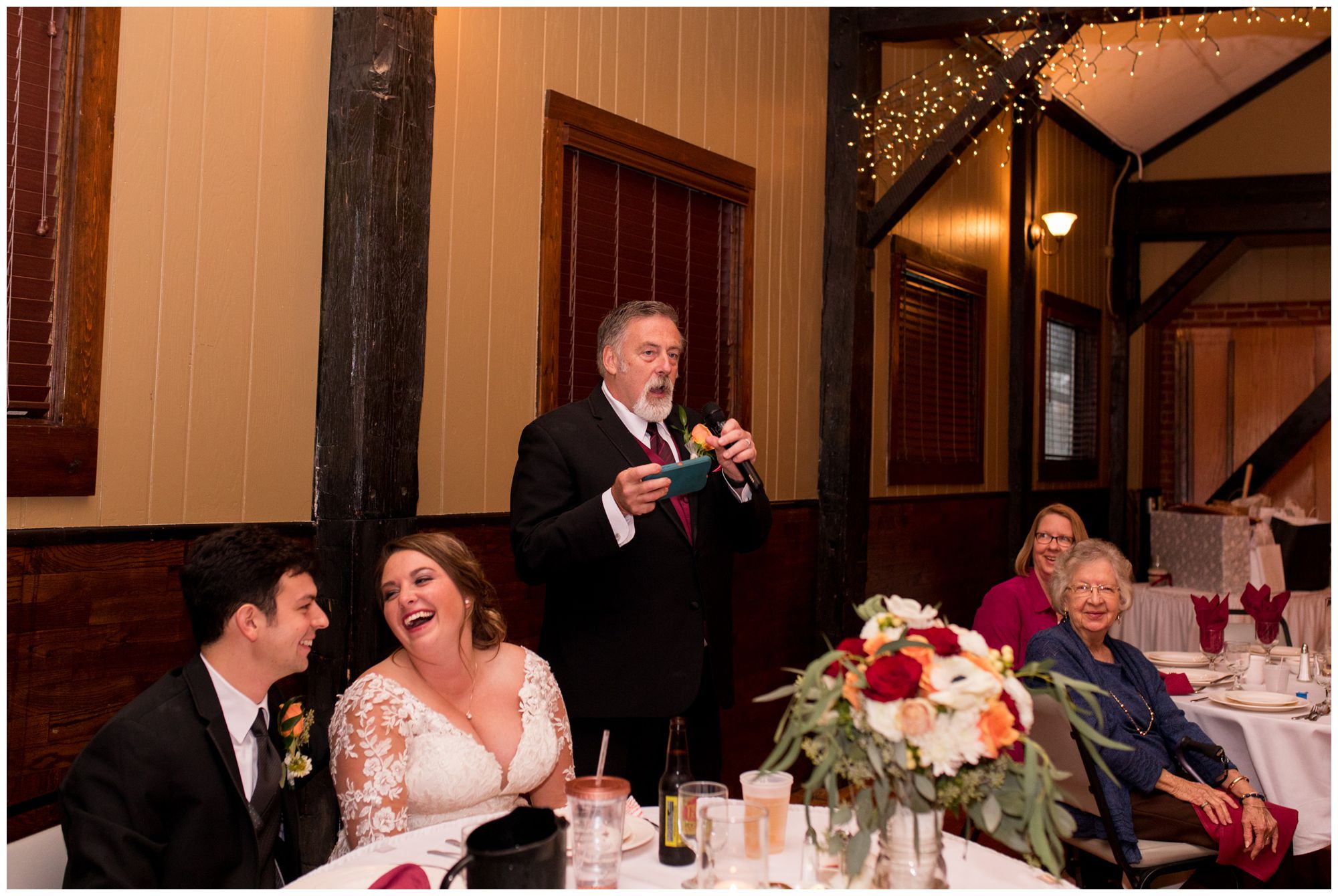 bride and groom laugh during father's welcome speech at Goeglein Homestead