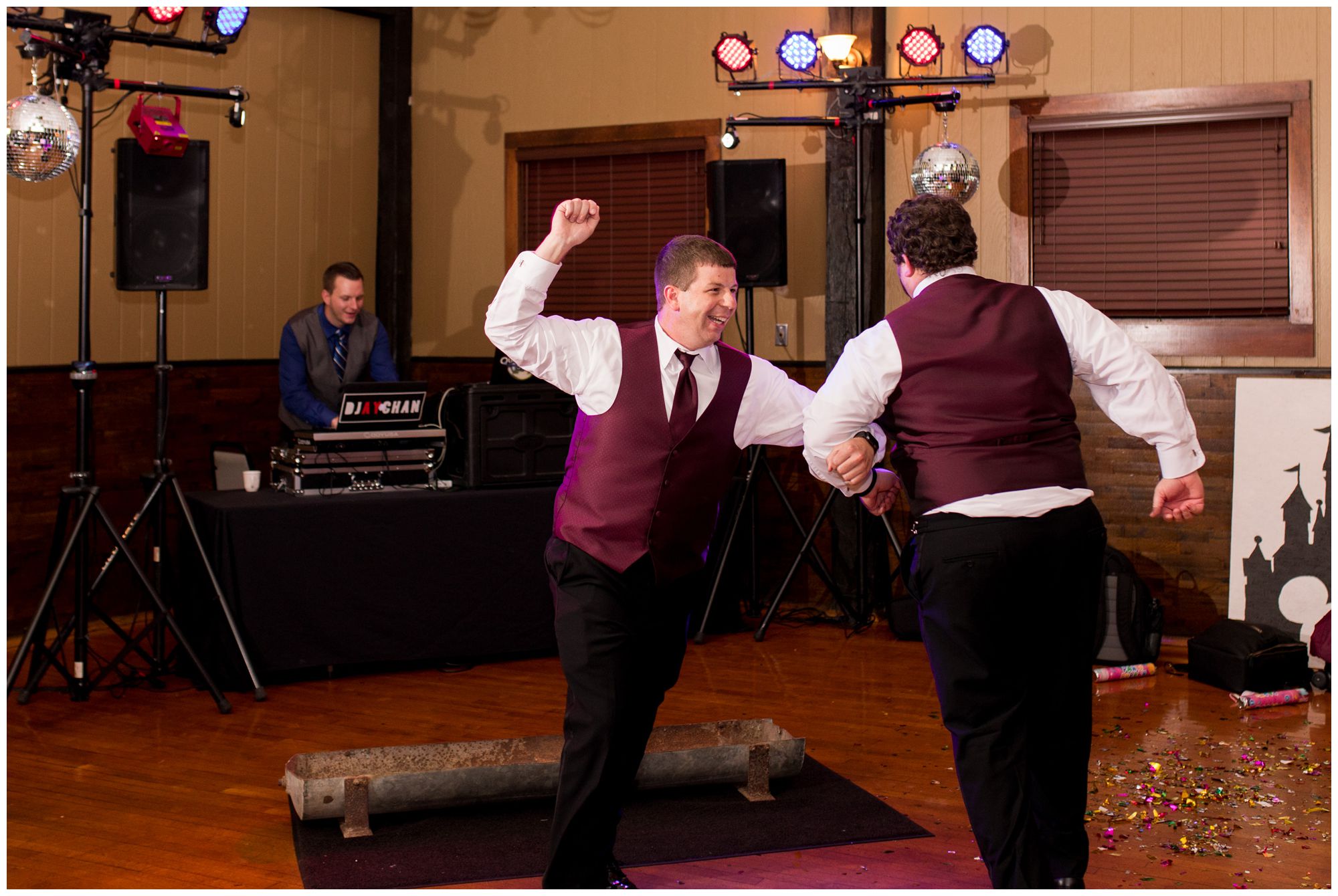 groom's brothers dance around hog trough during wedding reception at Goeglein Homestead