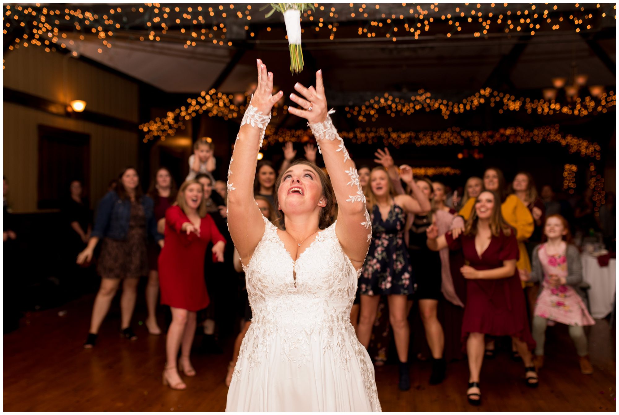 bride tosses bouquet during Goeglein Homestead reception
