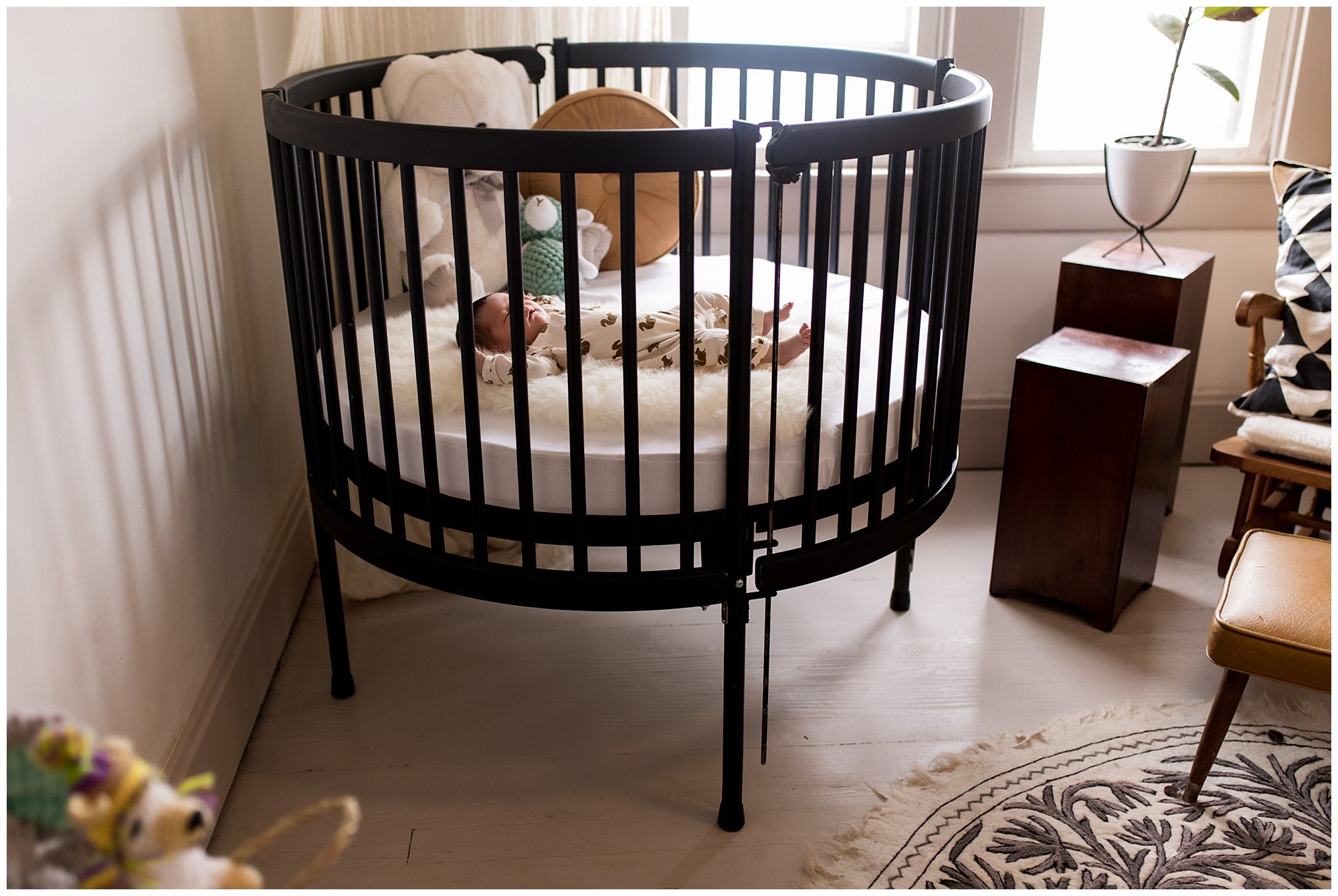 black circular crib in baby's neutral nursery in Indianapolis