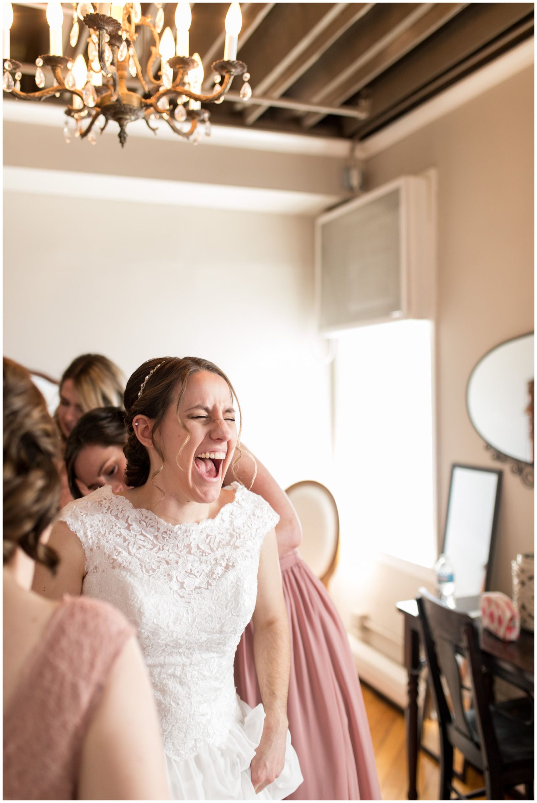 bride laughs while getting ready for Bread & Chocolate wedding in Goshen Indiana