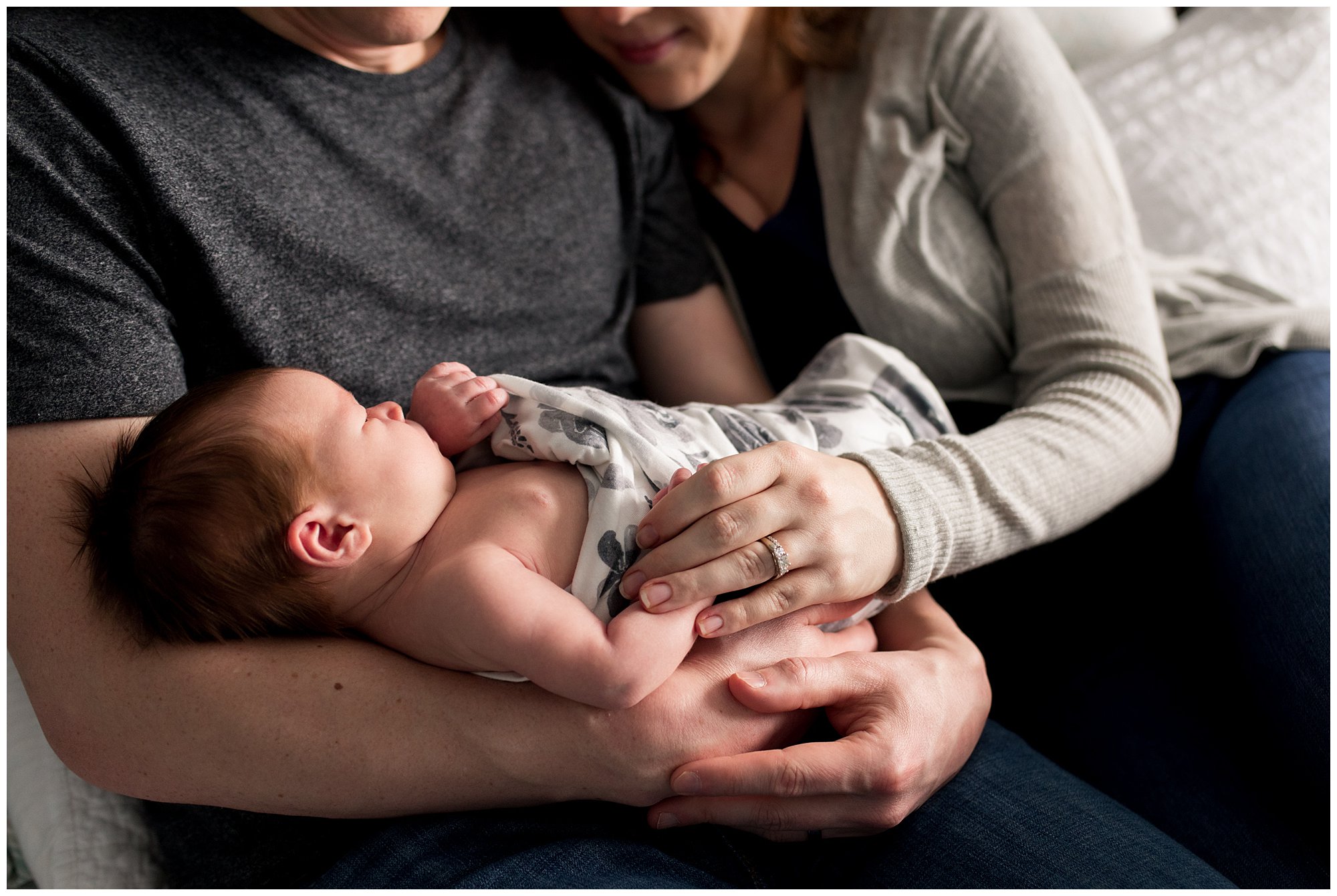 mom and dad hold baby with focus on hands during Columbus Indiana newborn session