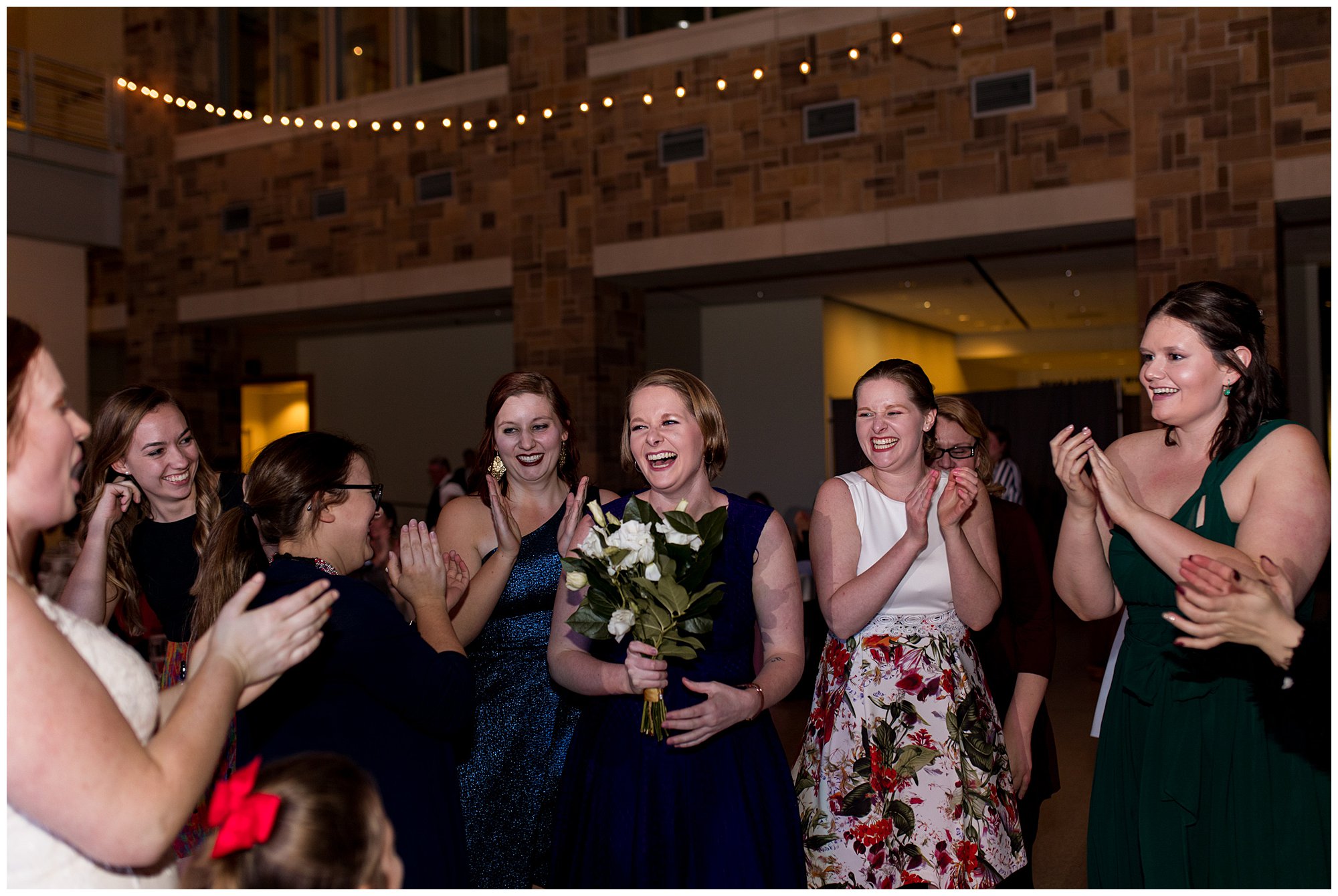 guest catches bouquet tossed by bride at Indiana State Museum