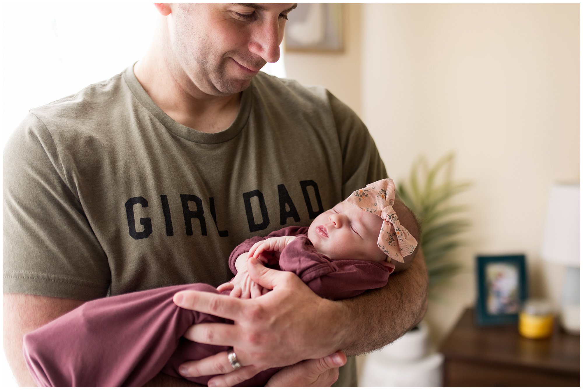 dad holds newborn with shirt that says girl dad
