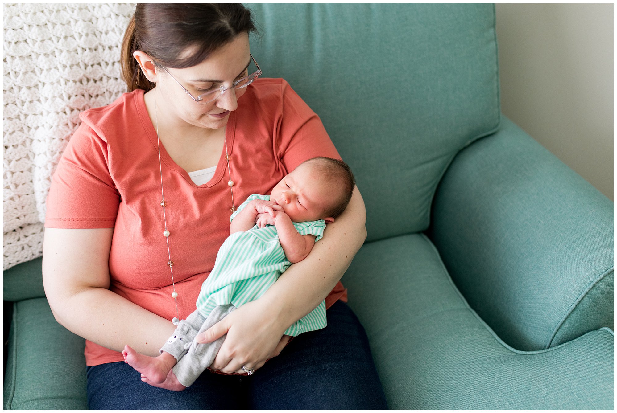 mom holds newborn baby during newborn session at home