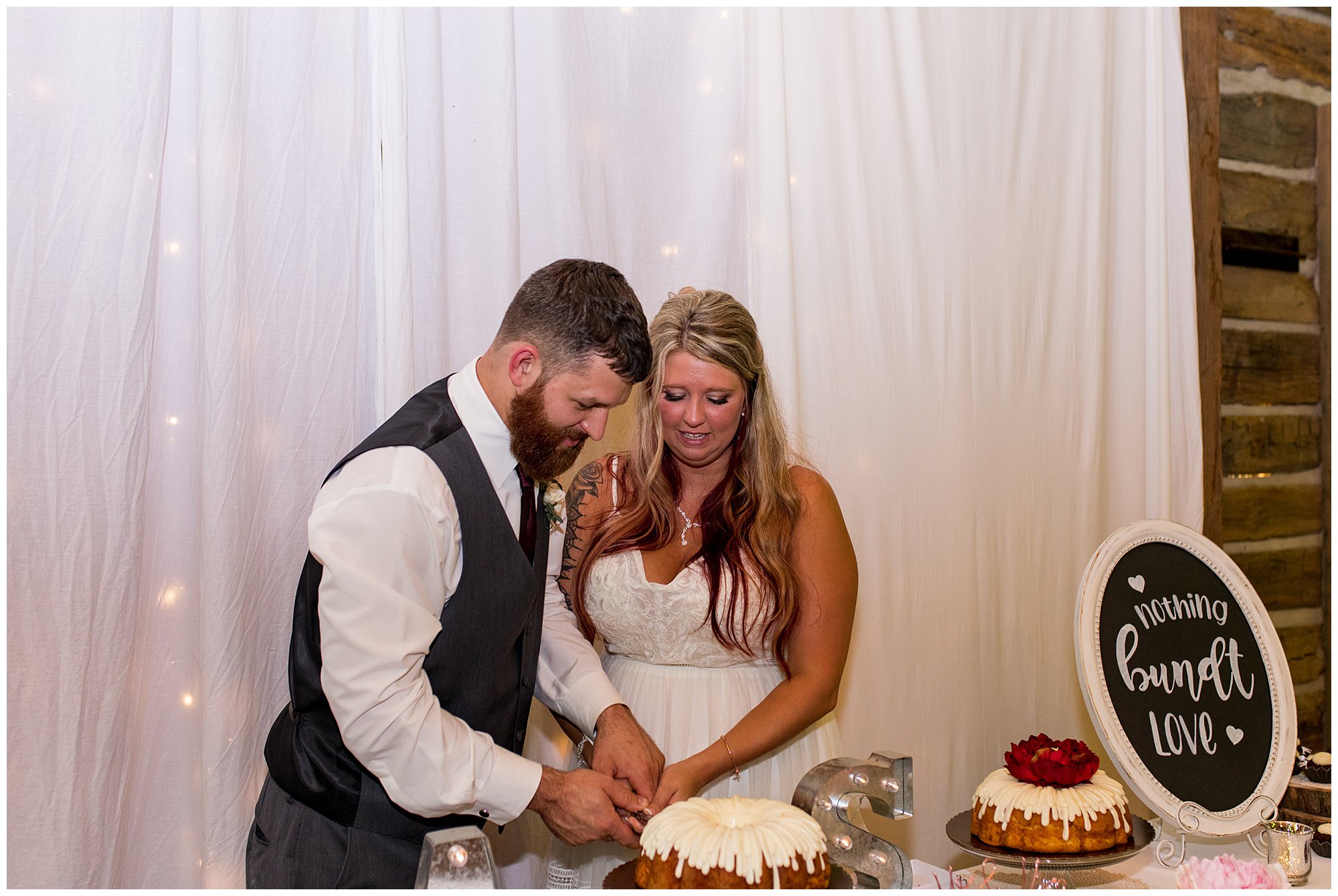 bride and groom cut wedding cake at The Old Mill Village