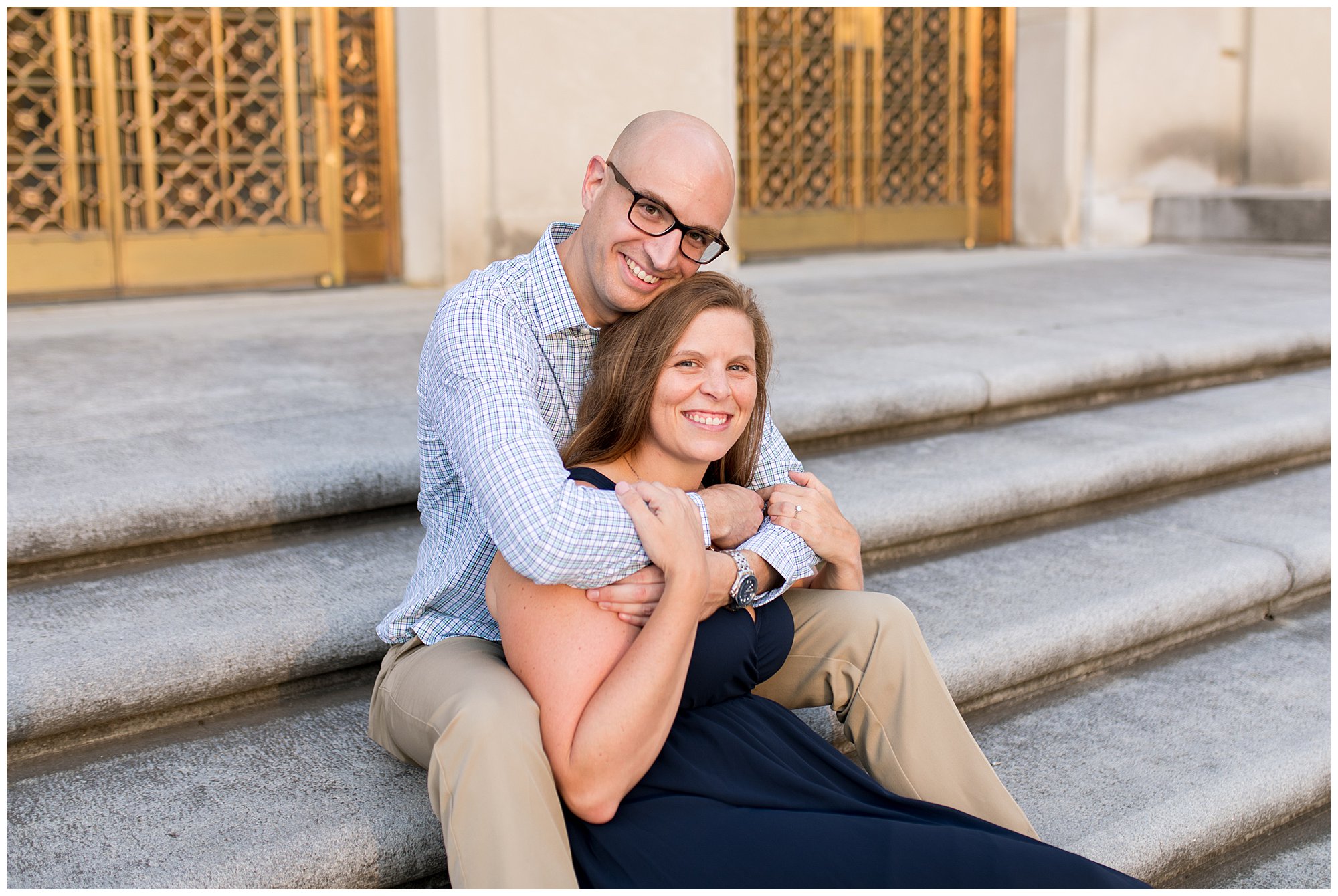 groom hugs bride at Indiana War Memorial engagement session in Indianapolis